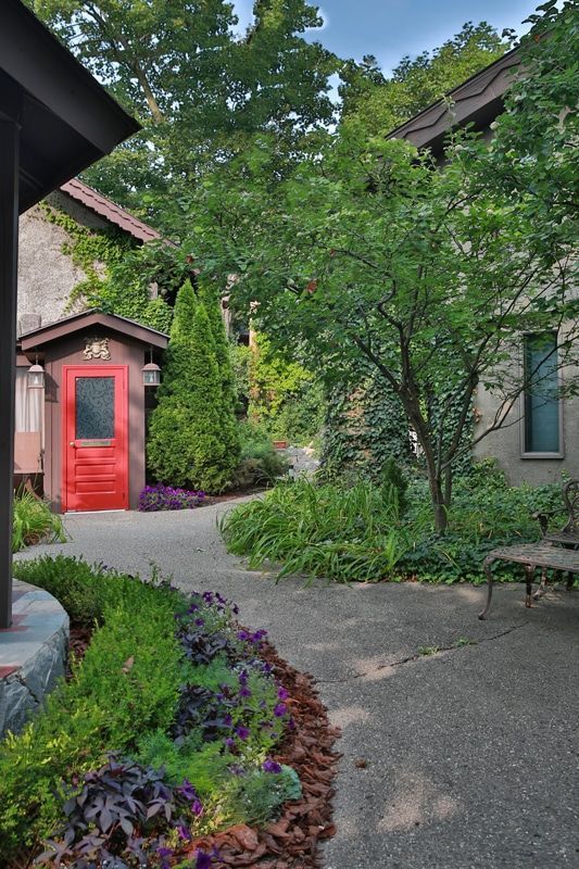 A red door is on the side of a house