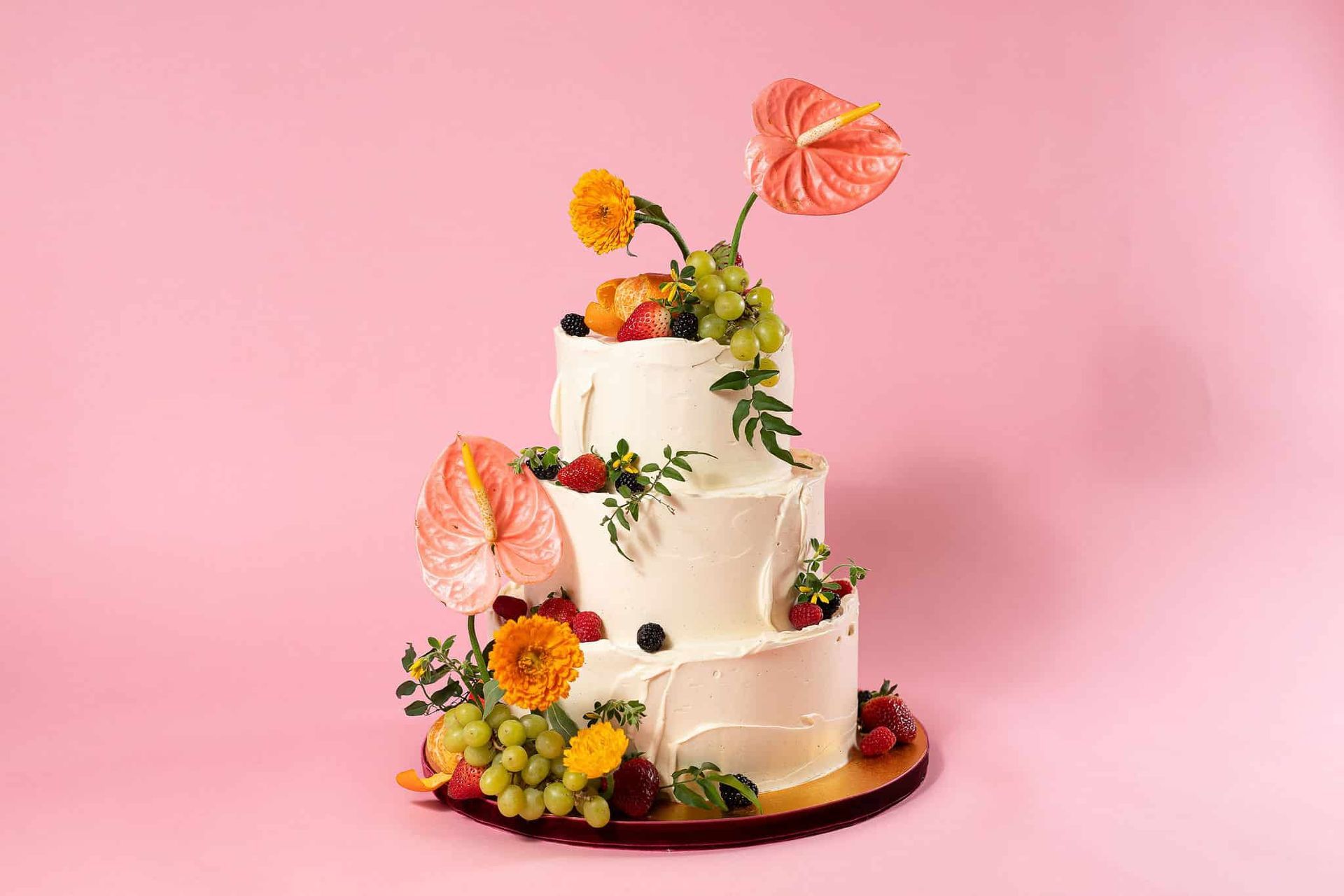A woman in a white dress is holding a bouquet of blue and white flowers.