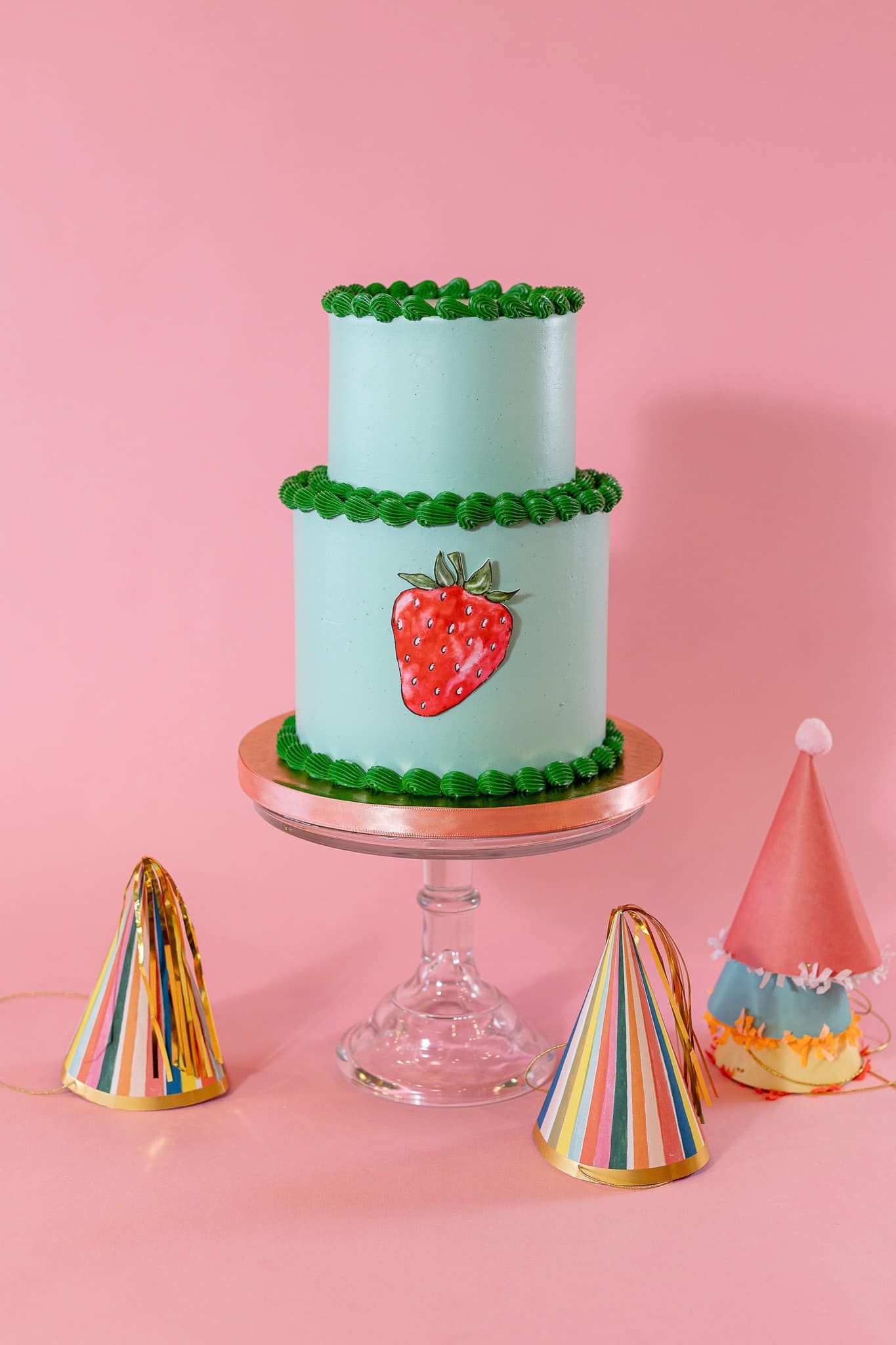 The bride is wearing a white cape and holding a bouquet of white flowers.