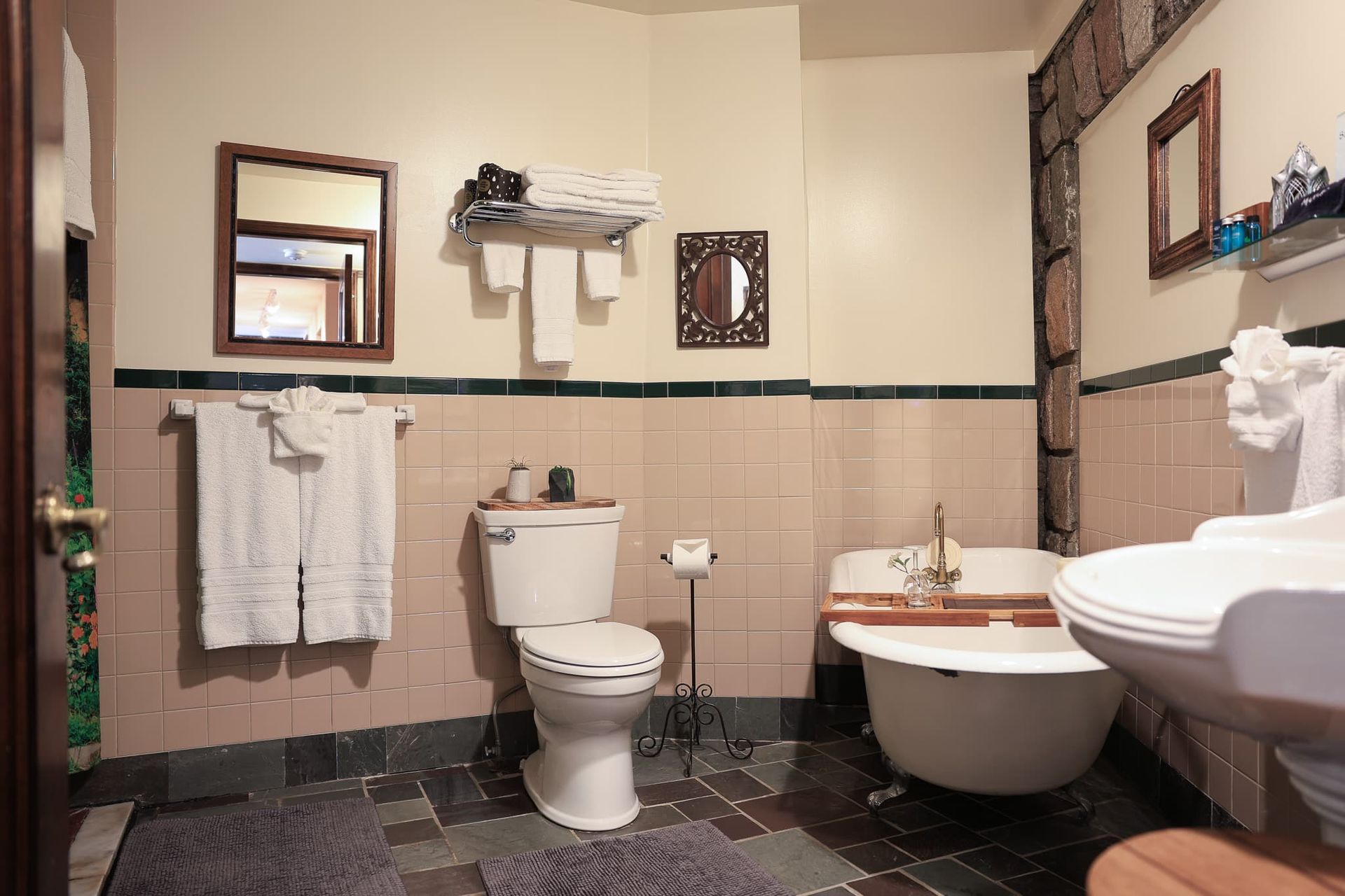 A bathroom with a toilet , sink and bathtub