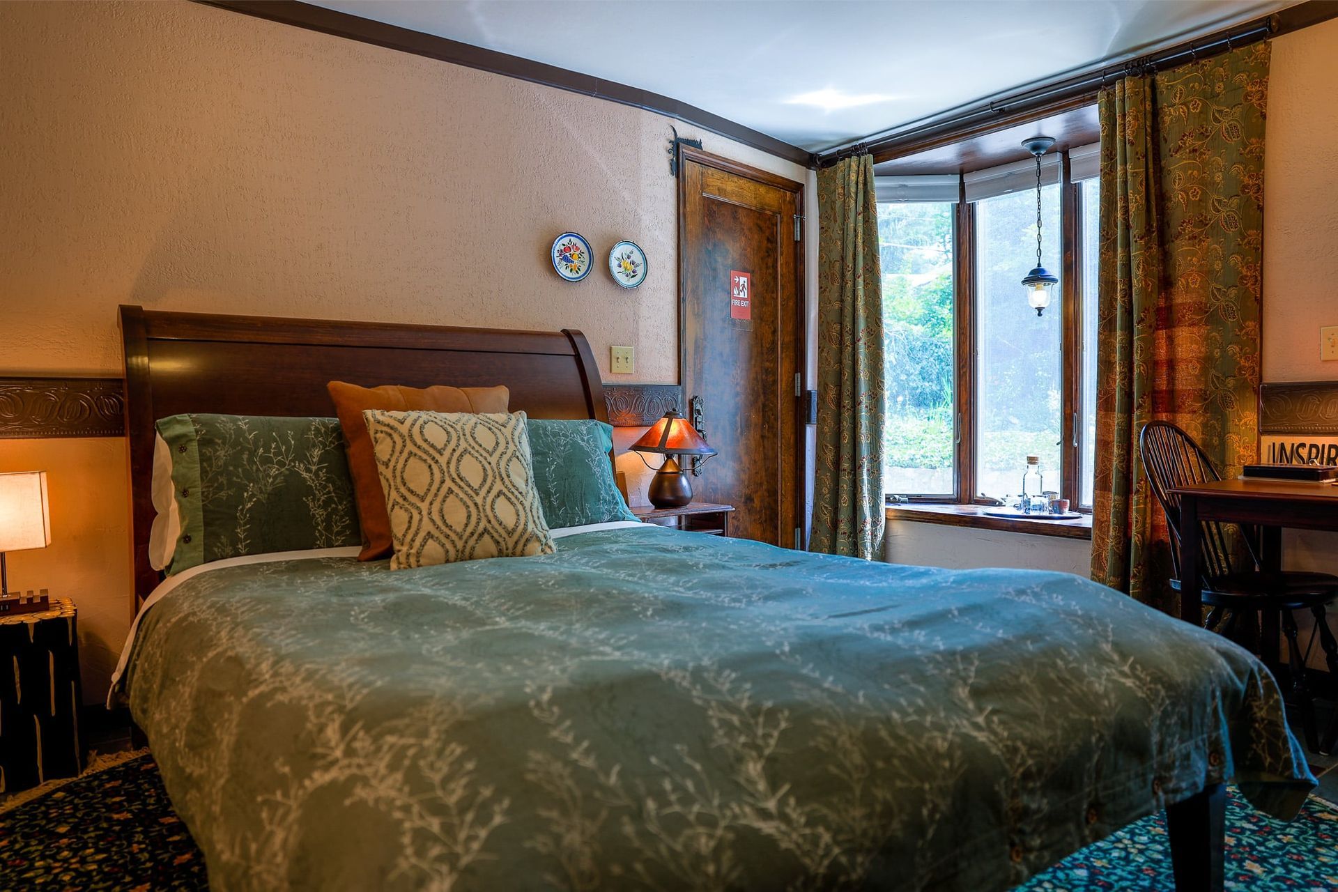 A hotel room with a king size bed and a window.