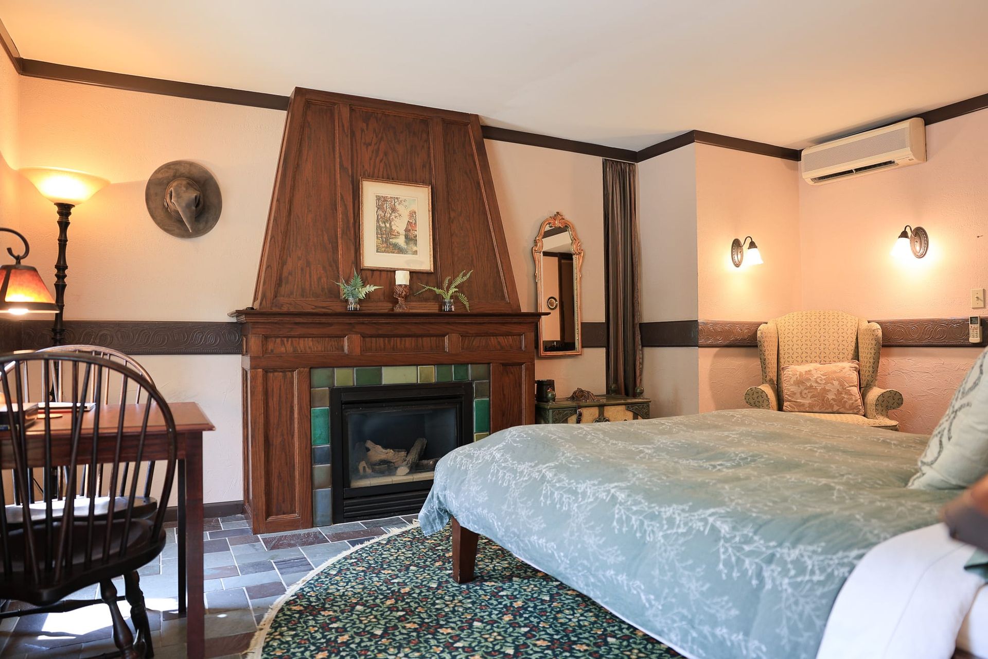 A bedroom with a fireplace and a bed