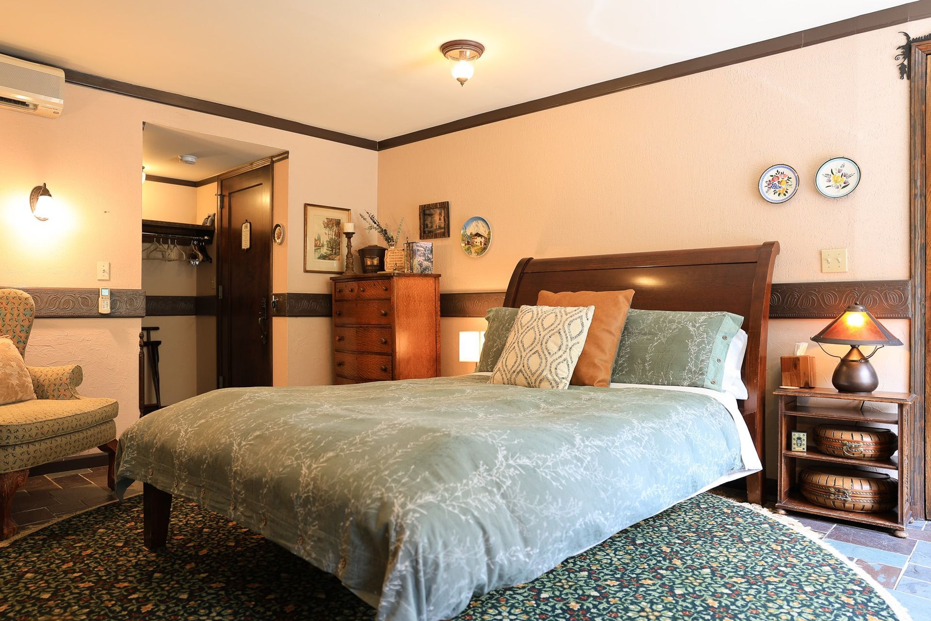 A bedroom with a king size bed and a chair