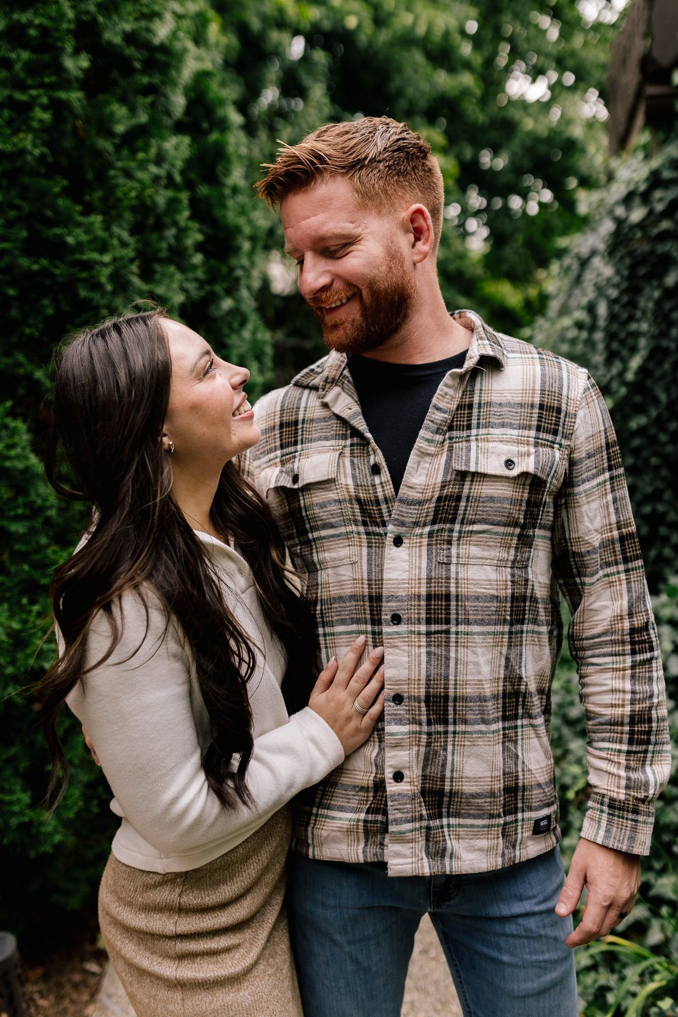 A man and a woman are standing next to each other and looking at each other.