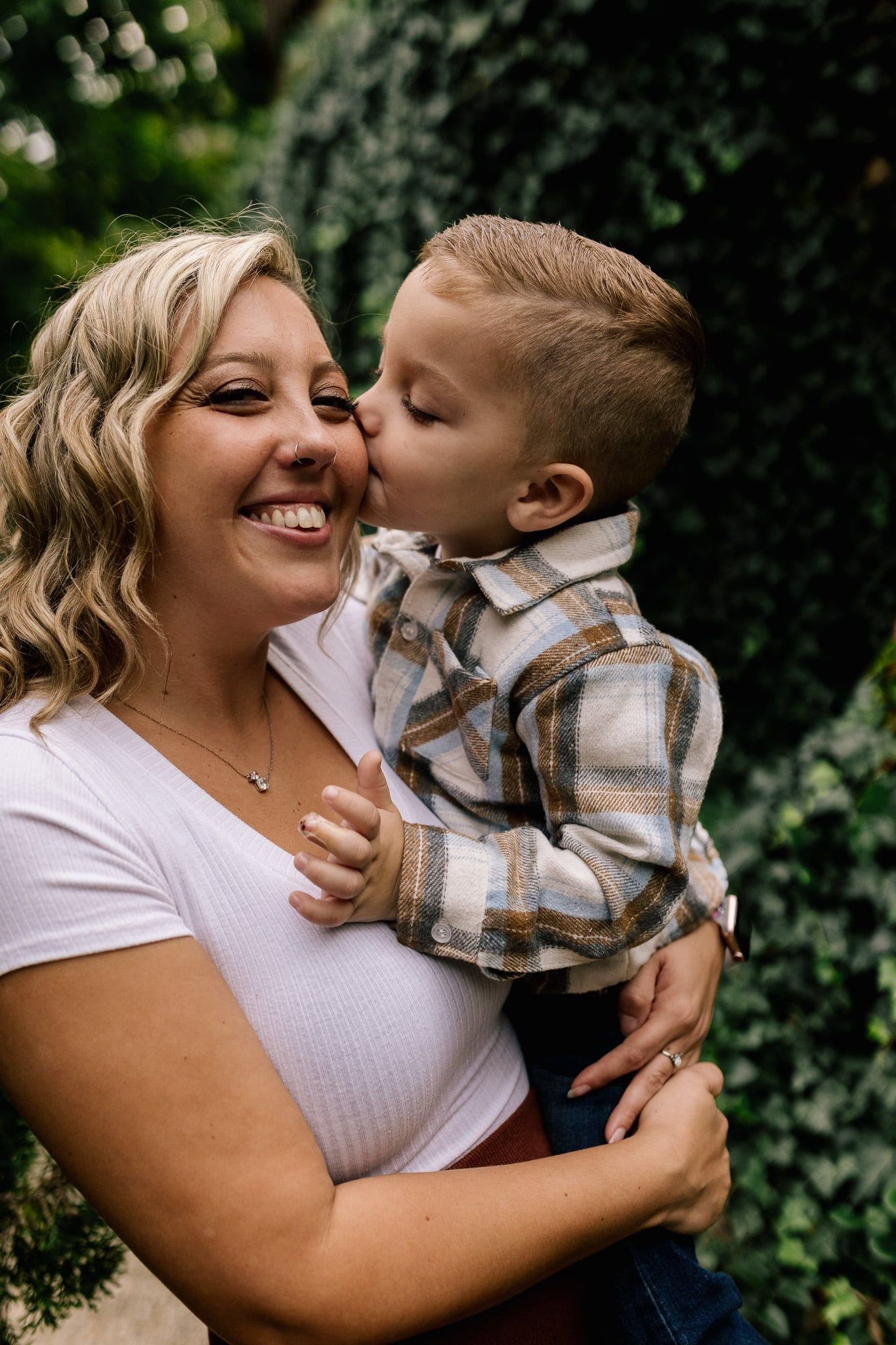 Kid kissing his mother