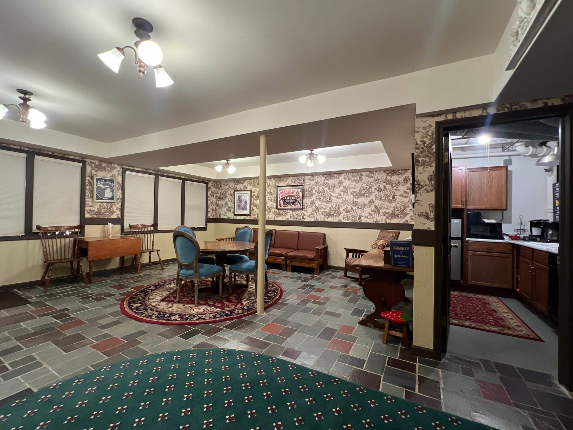 A living room with a table , chairs , and a piano.