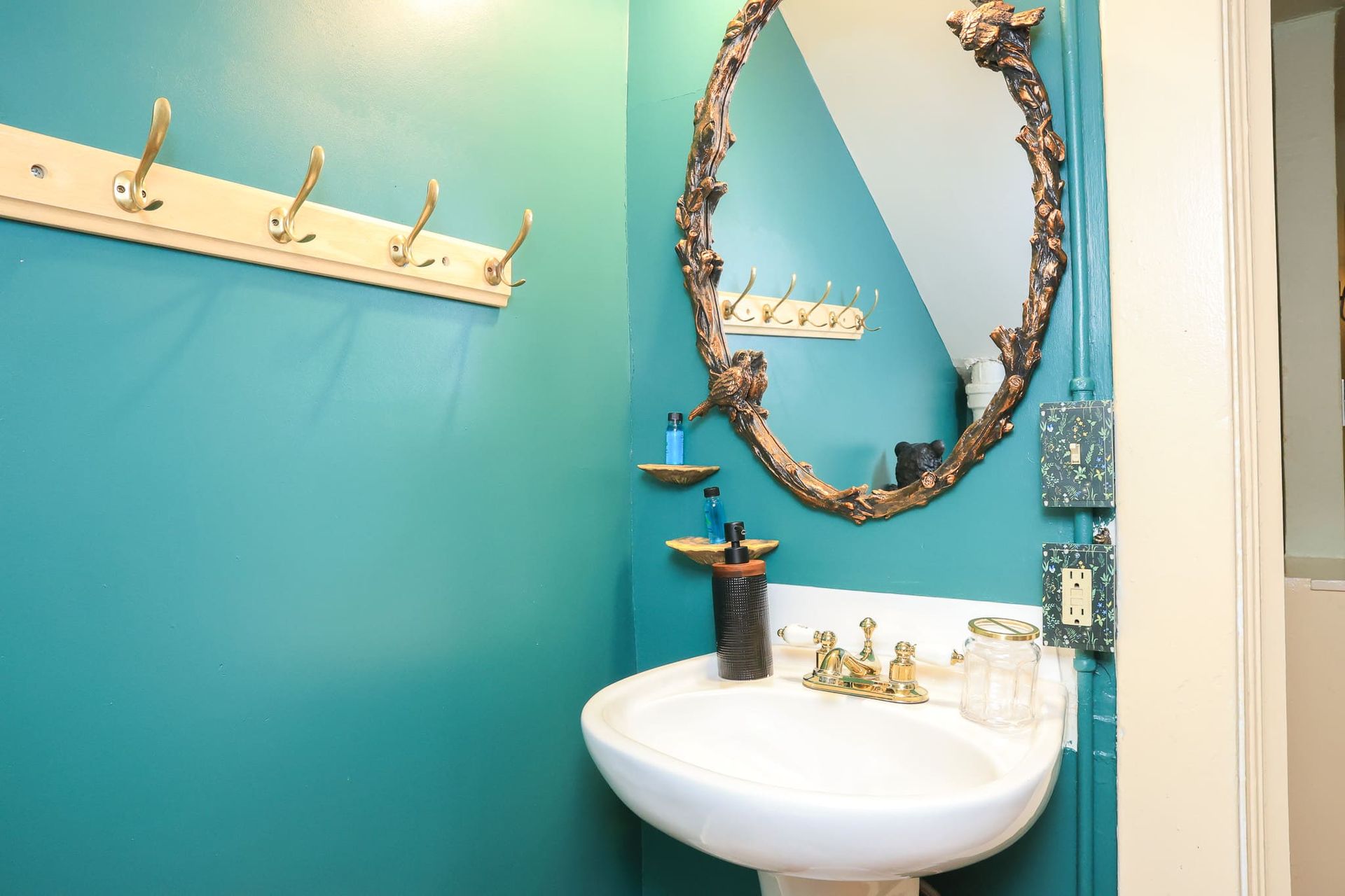 A bathroom with a sink and a mirror on the wall.