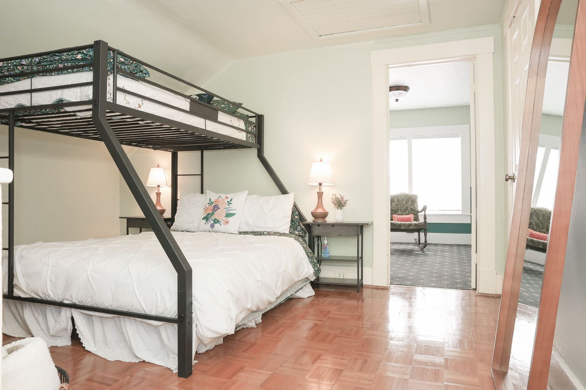 A bedroom with a bunk bed and a king size bed.