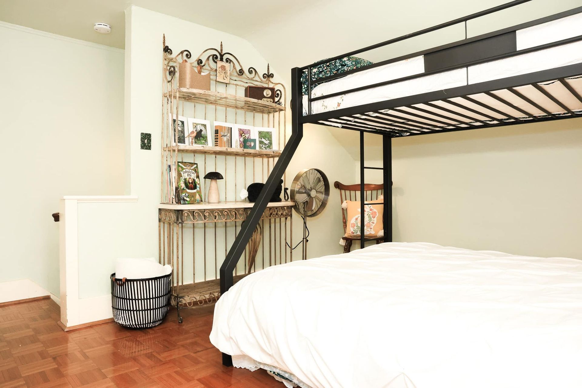 A bedroom with a bunk bed and a desk.