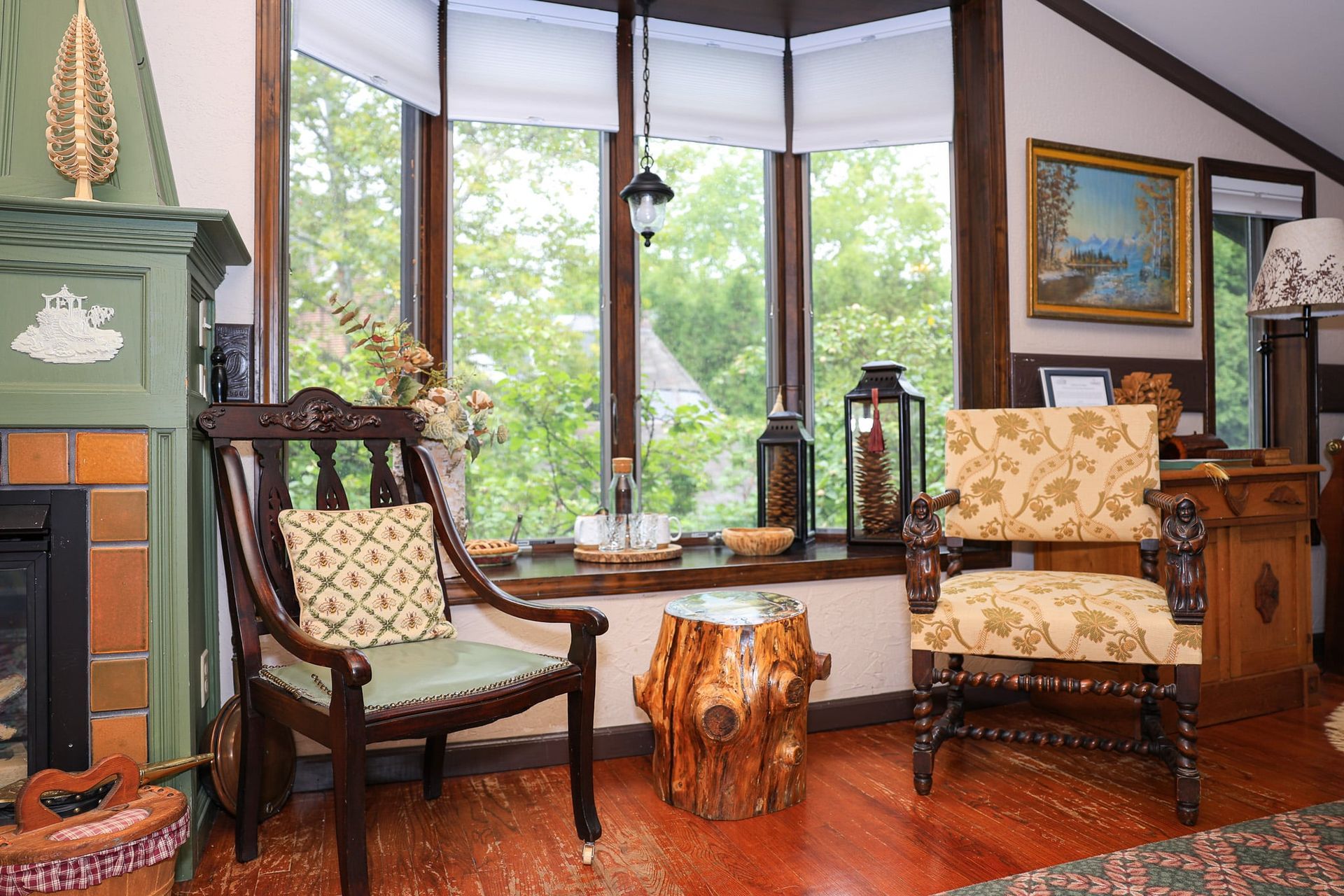 A living room with a fireplace , chairs , and a table.