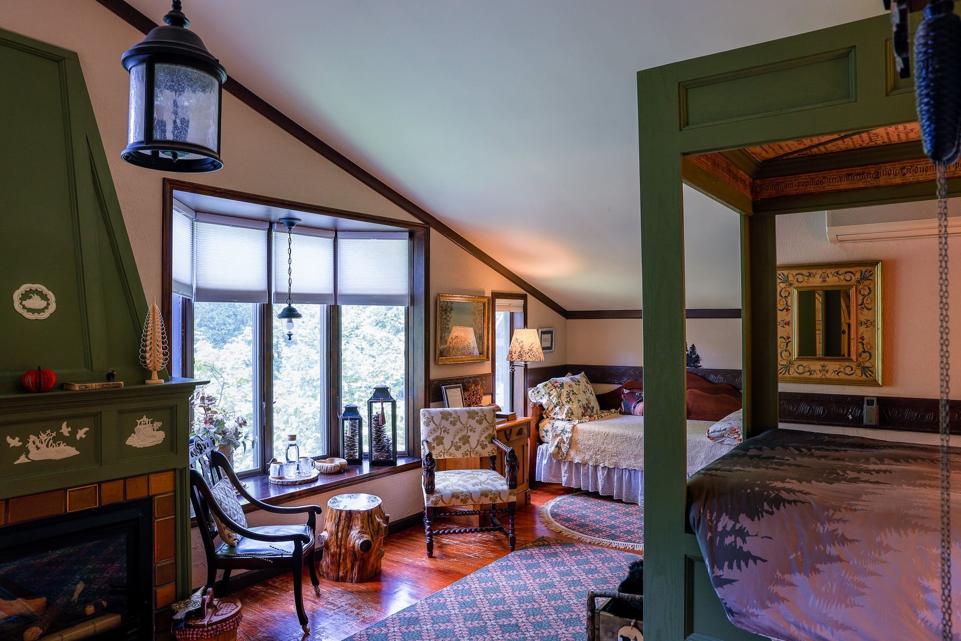 A bedroom with a four poster bed and a fireplace.