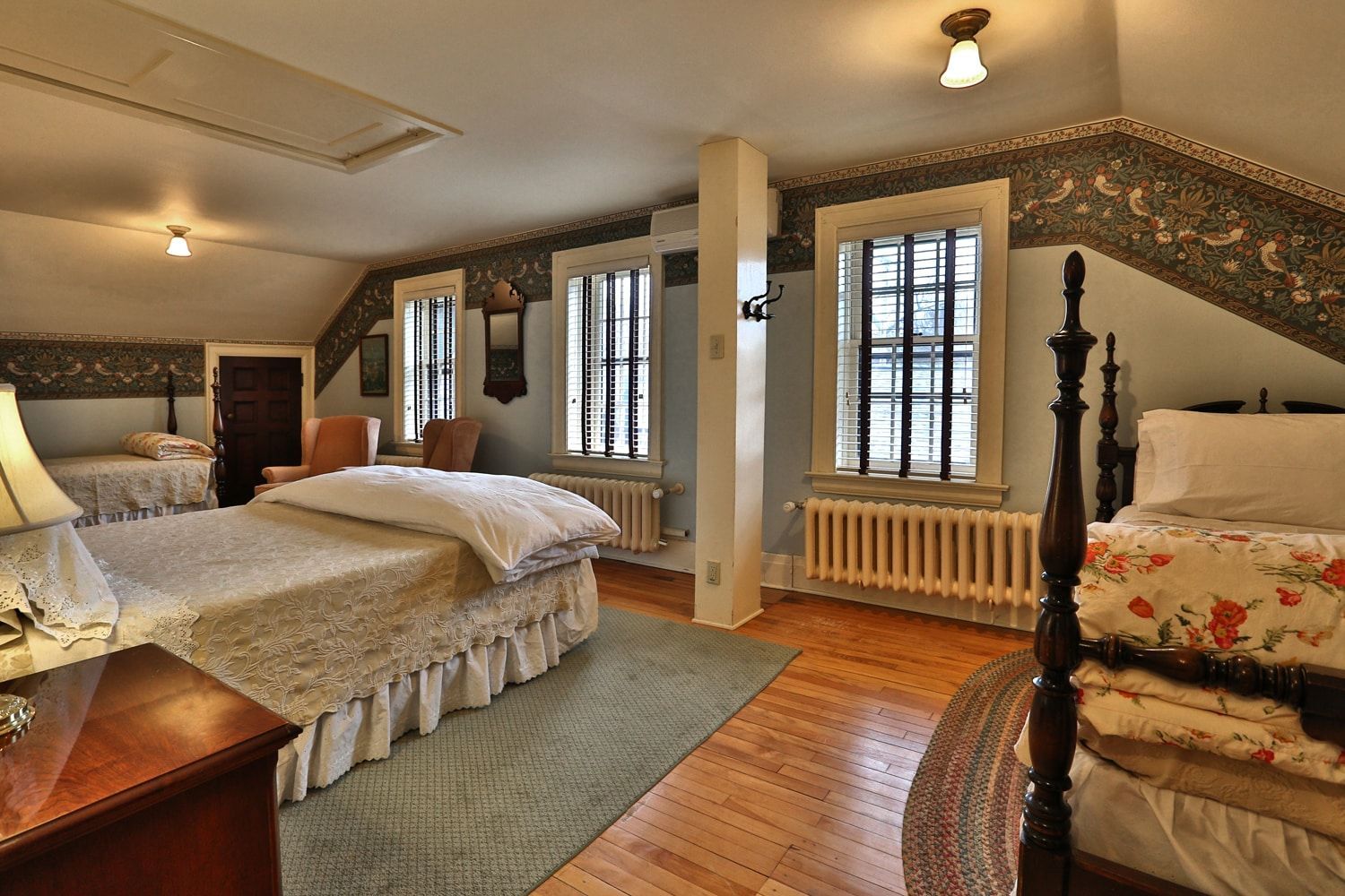 A bedroom with two beds and a dresser