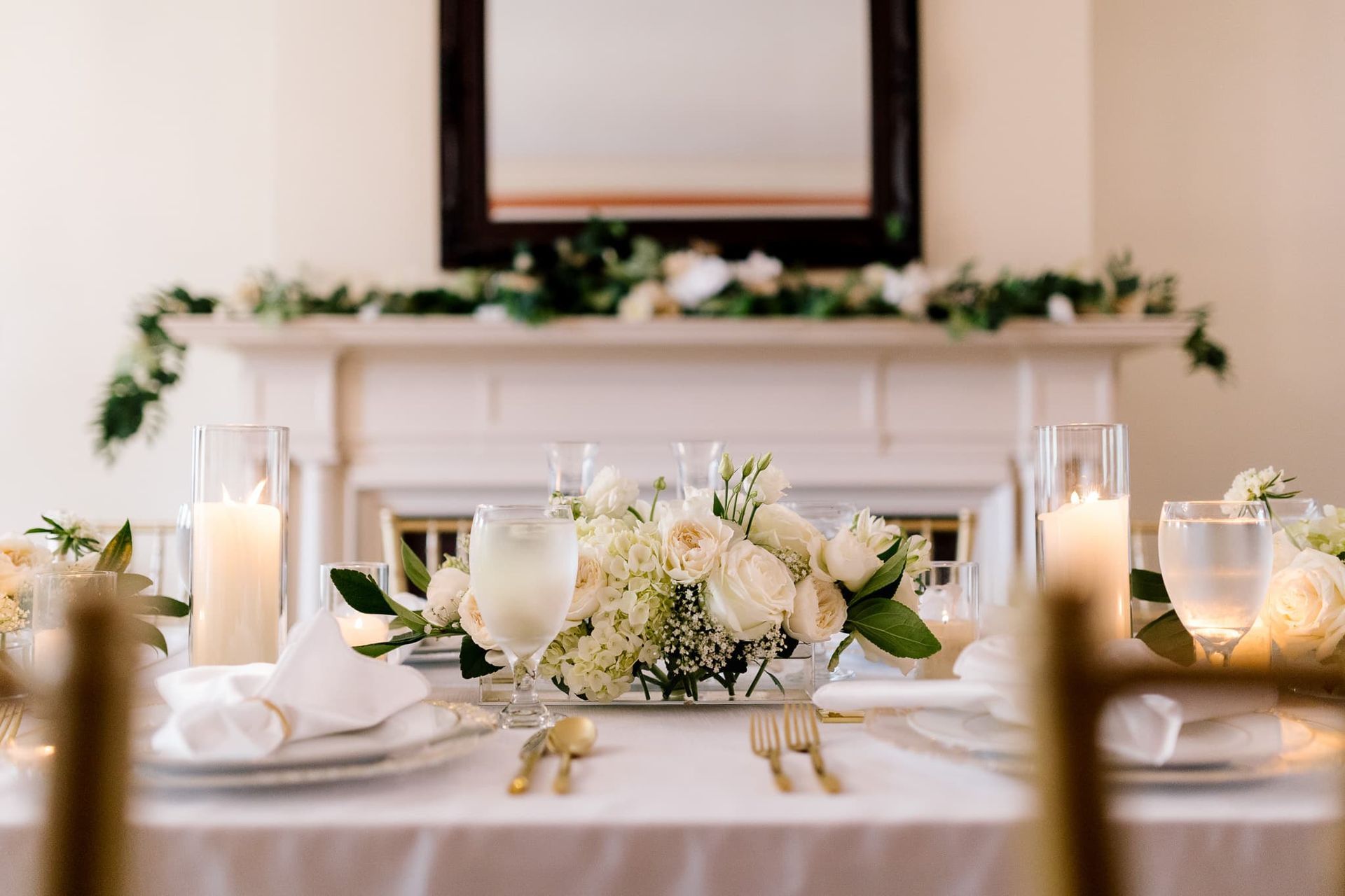 A table set for a wedding reception with a fireplace in the background.