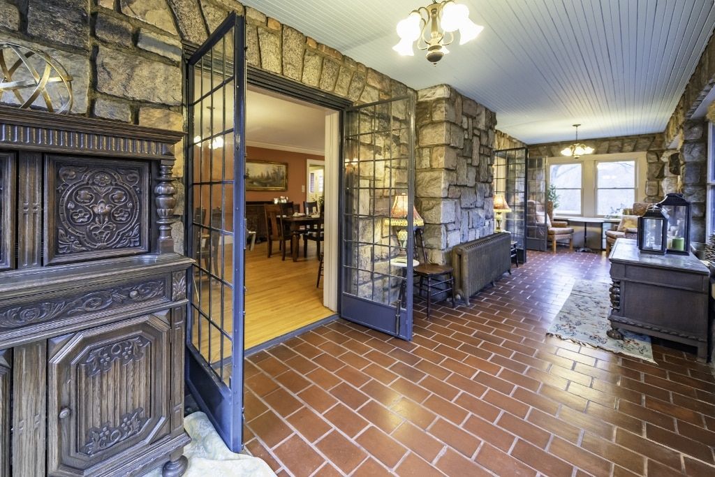 A living room with a brick wall and a brick floor