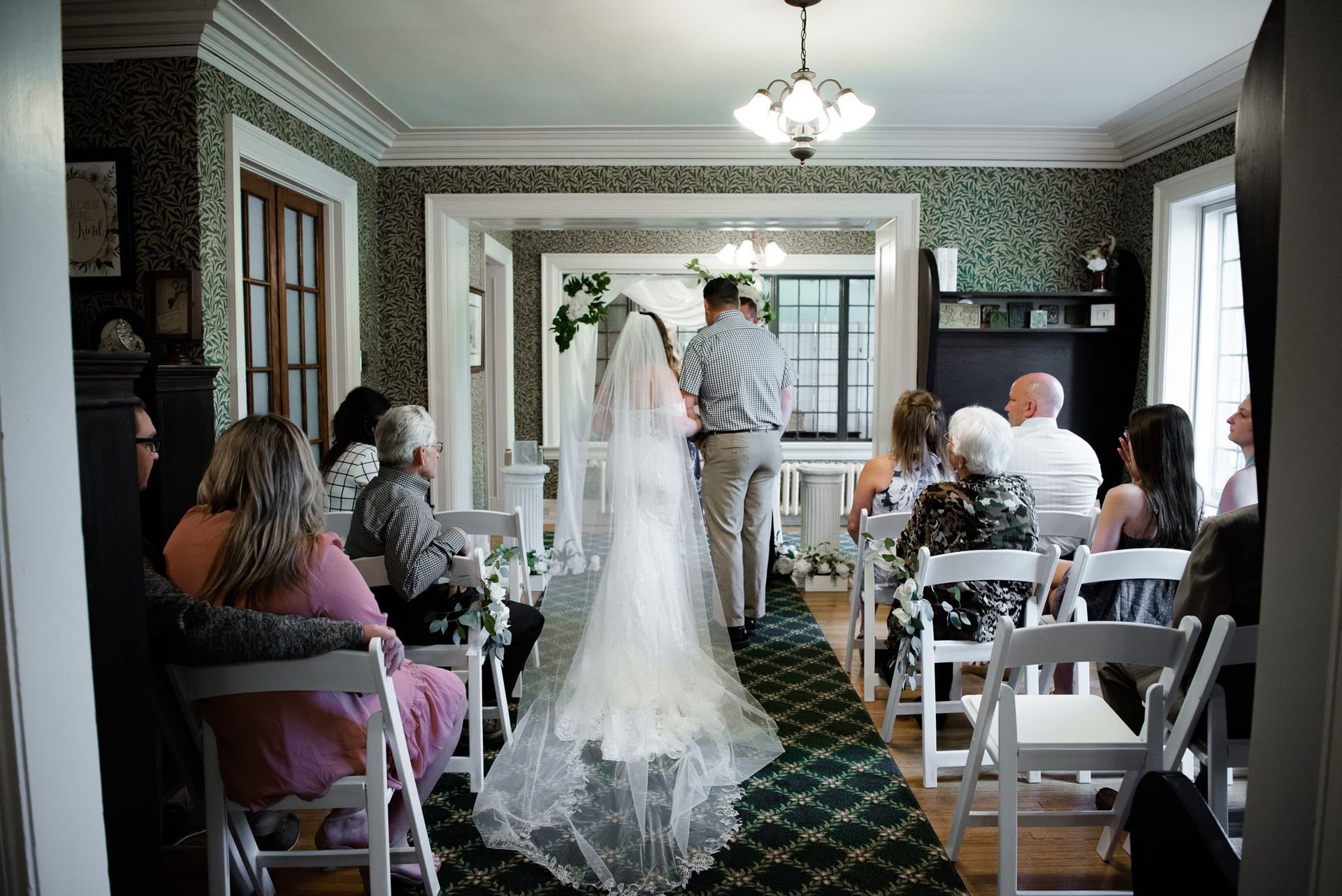A bride and groom are walking down the aisle at a wedding ceremony.