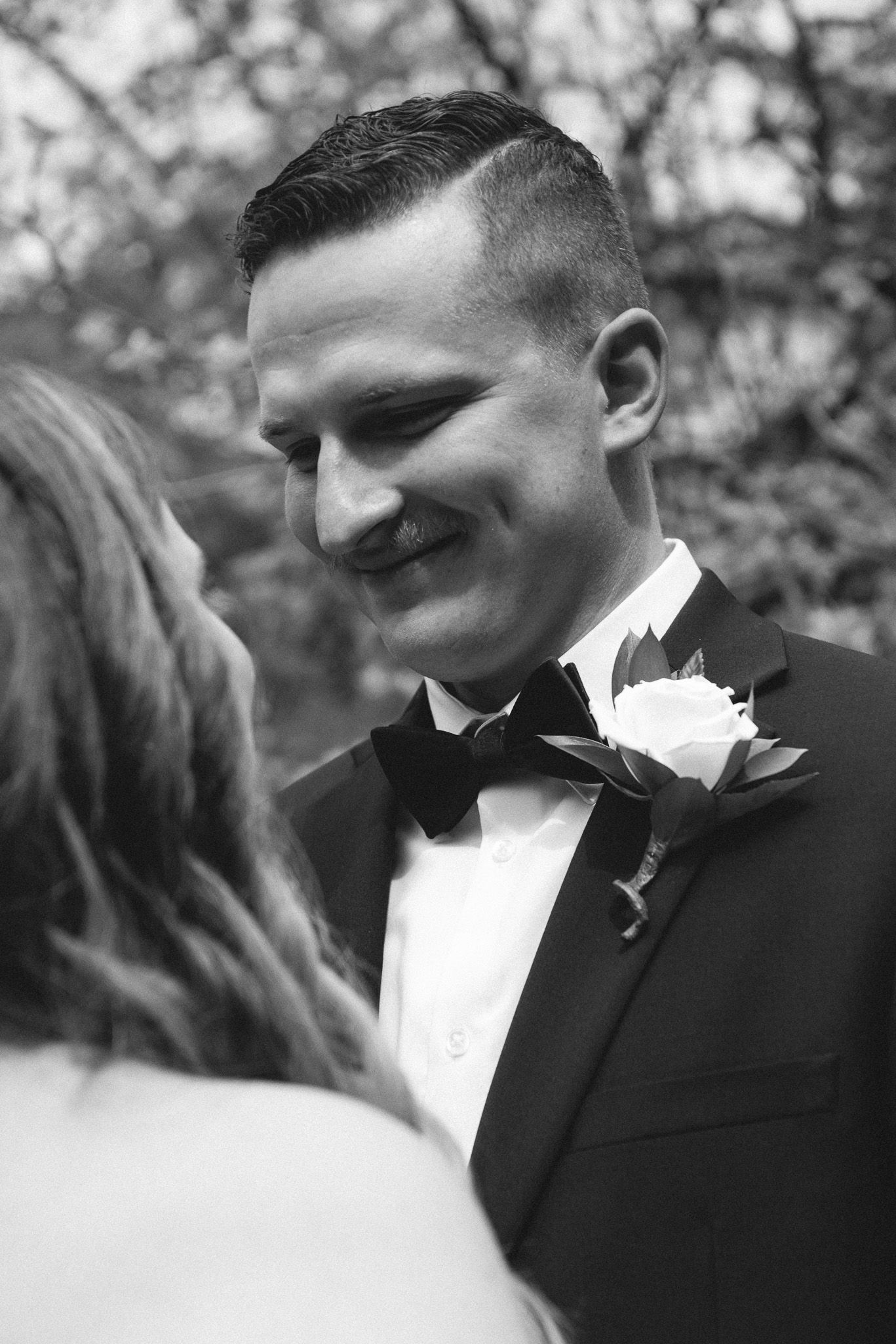 A black and white photo of a bride and groom looking at each other.