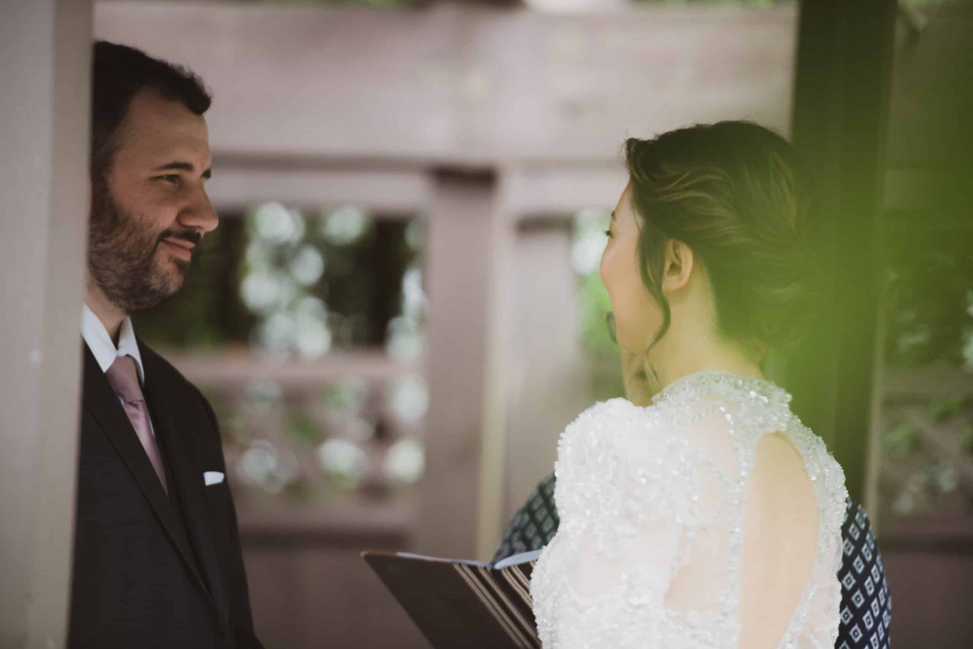 A bride and groom are standing next to each other during their wedding ceremony.