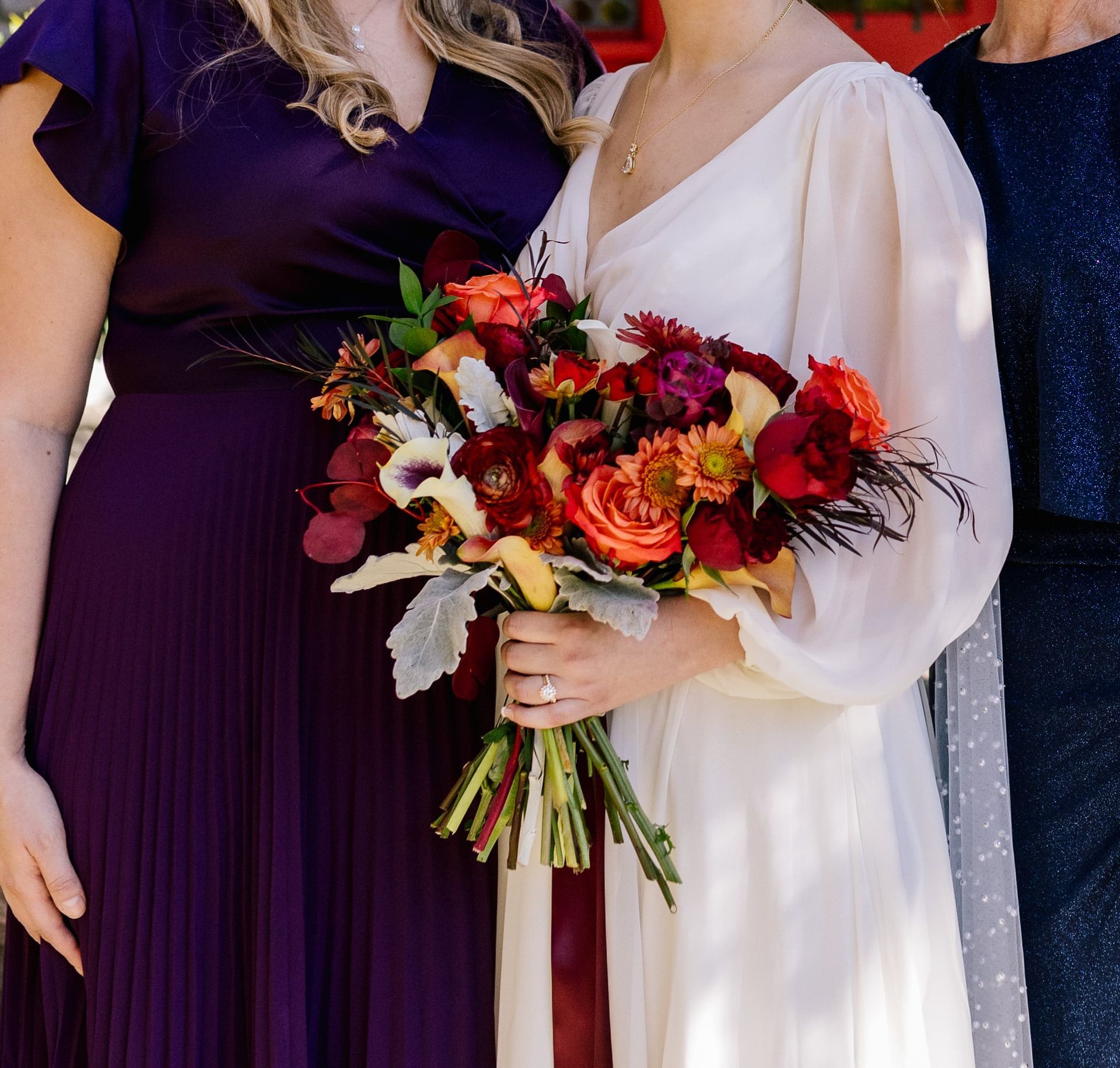 A woman in a white dress is holding a bouquet of flowers