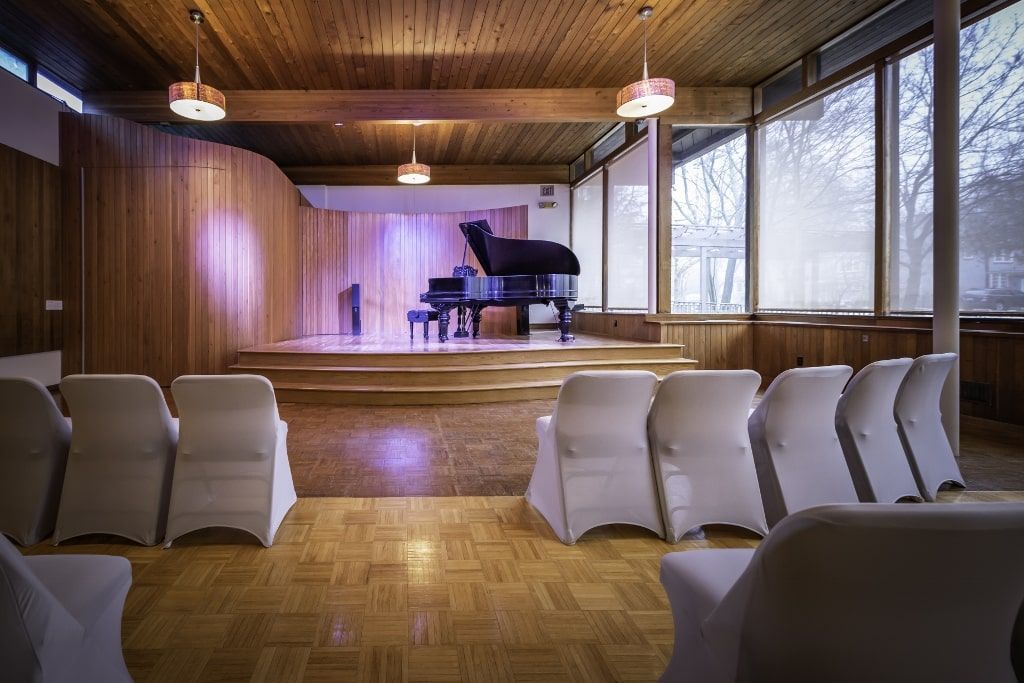 There is a piano in the middle of the room.