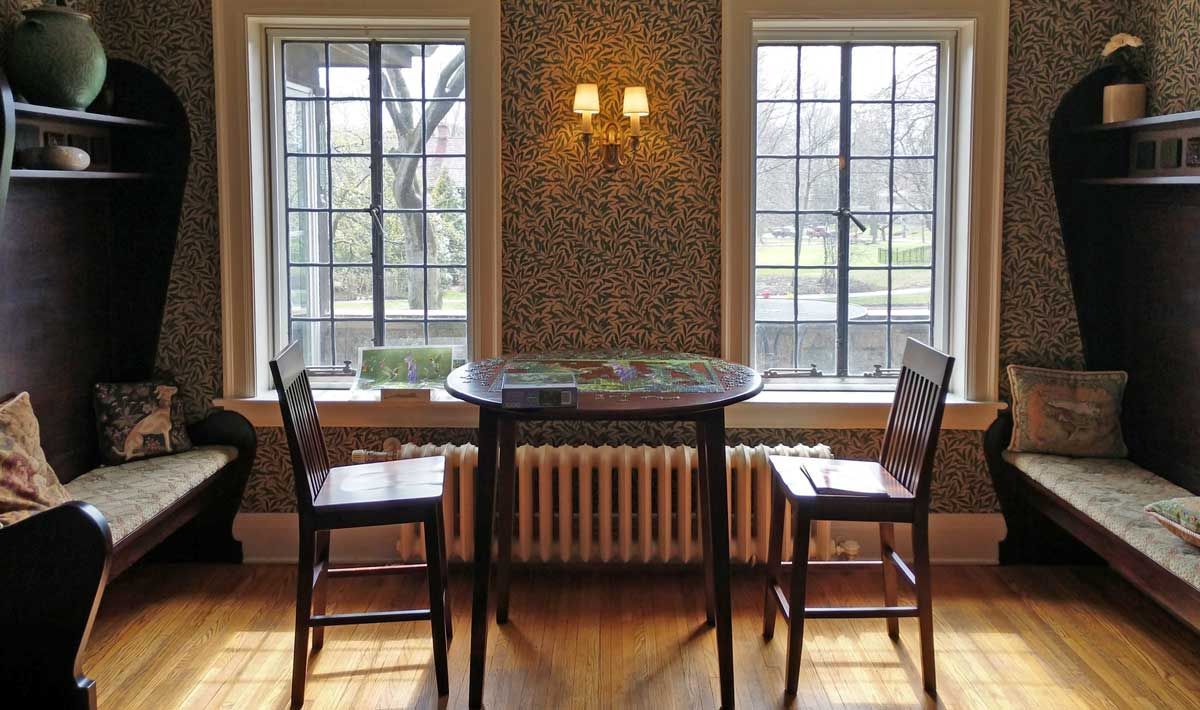 A room with a table and chairs and a radiator