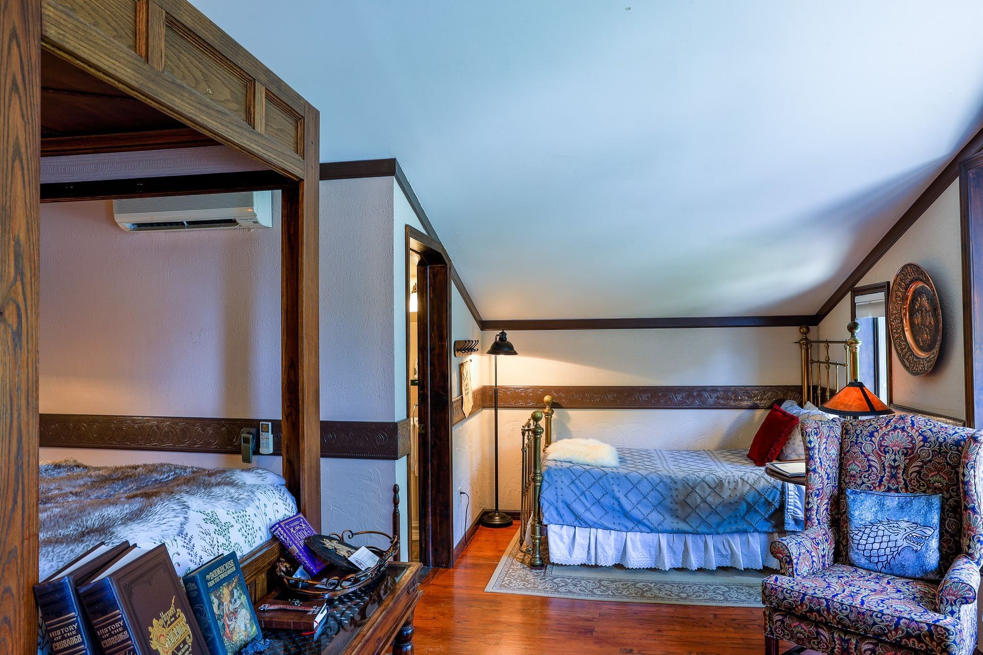 A bedroom with two beds and a chair in it