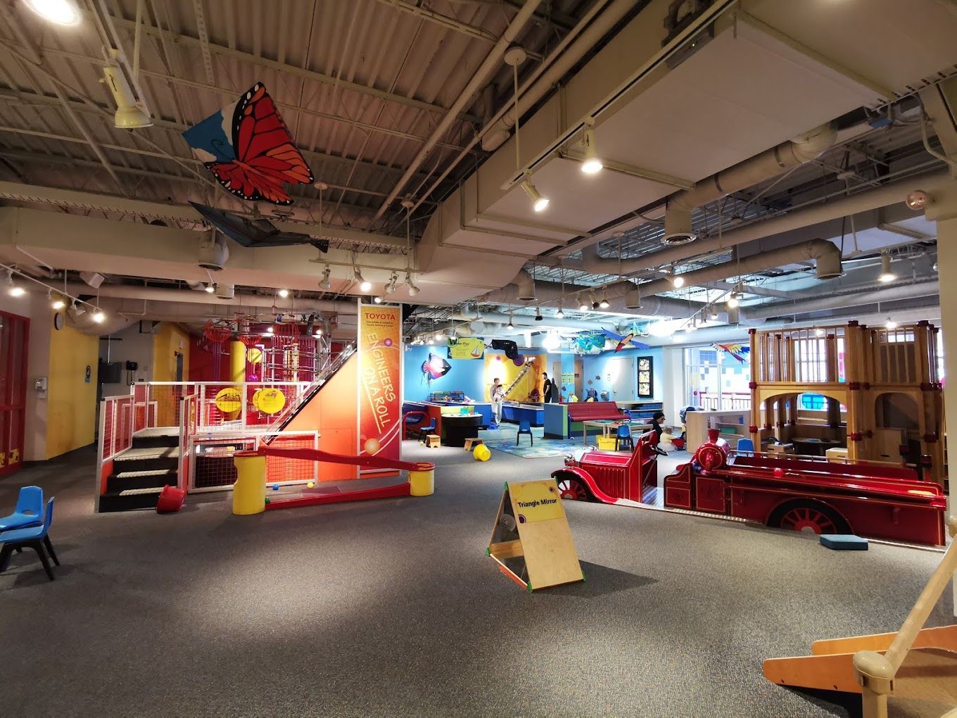A large play area with a butterfly hanging from the ceiling