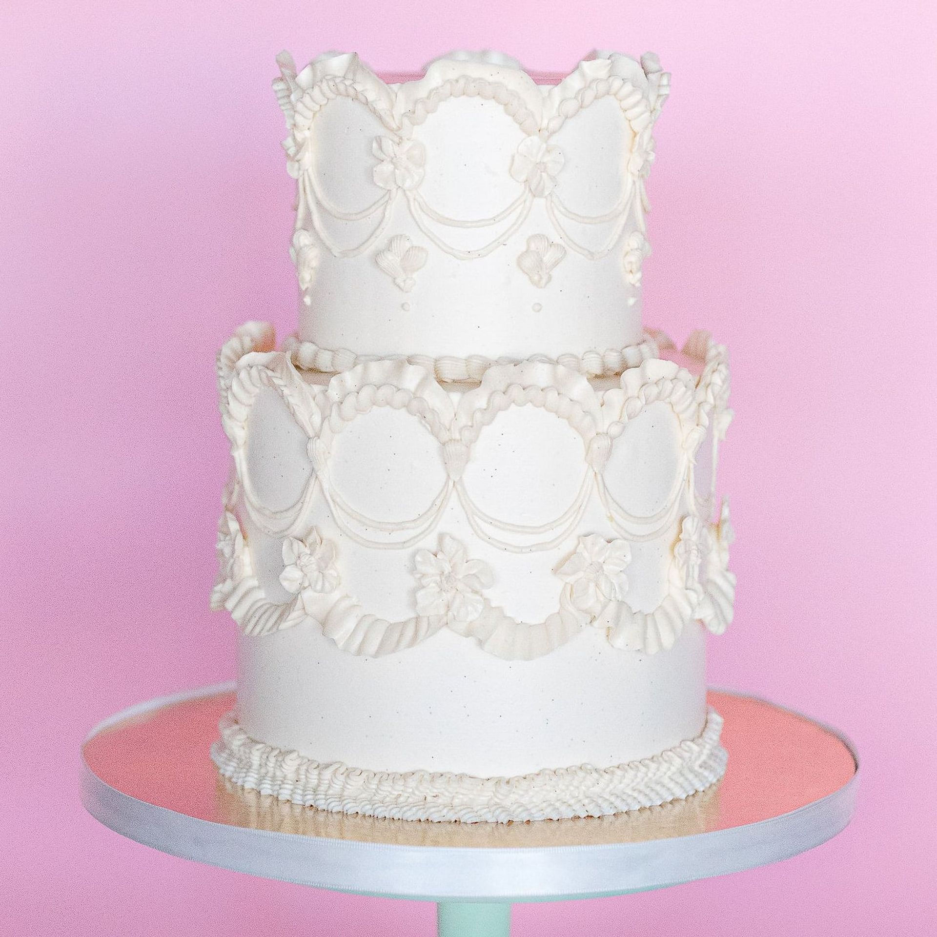 A man is kissing a woman who is holding a bouquet of flowers.