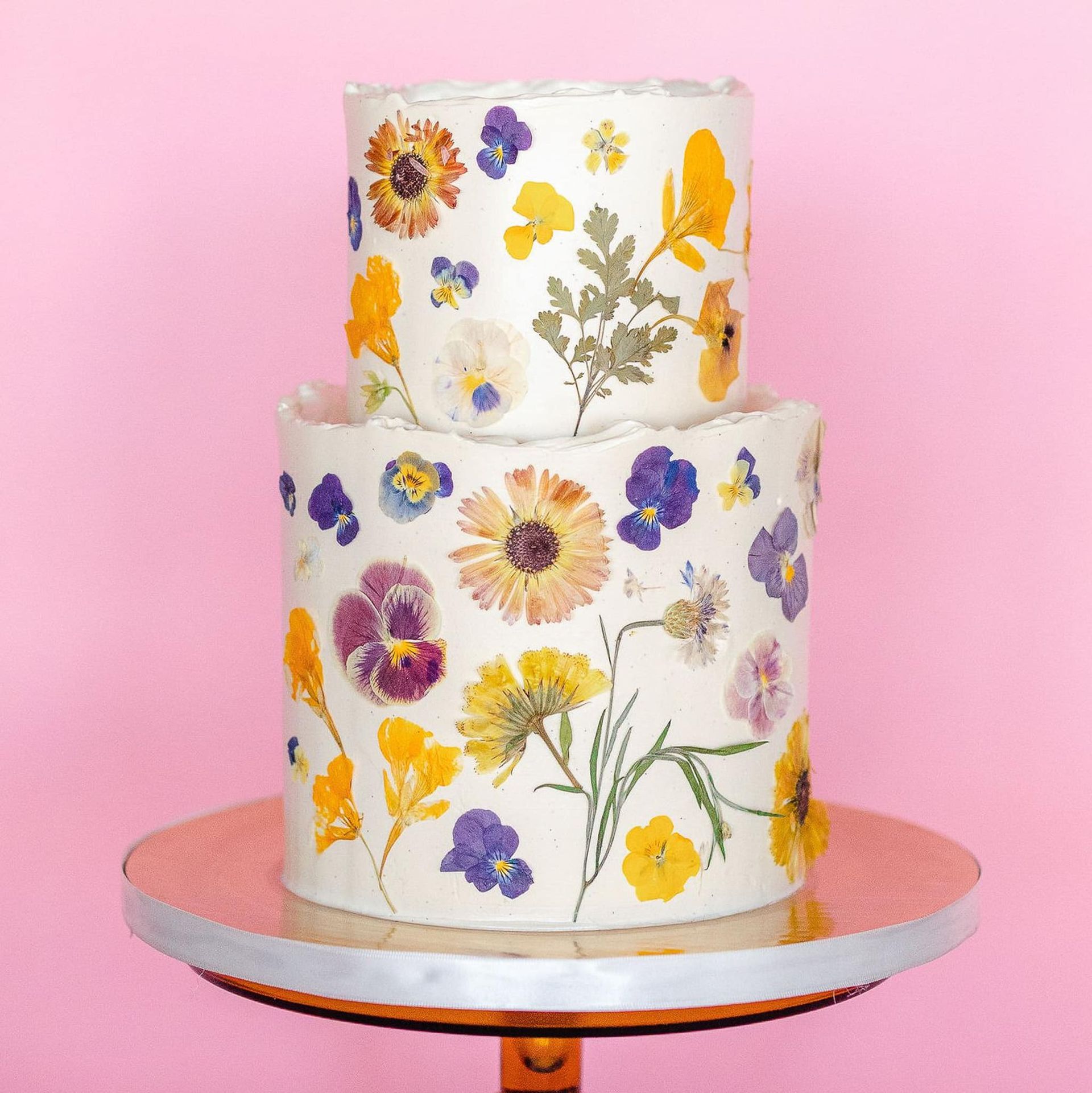 A bride in a wedding dress is holding a bouquet of flowers.
