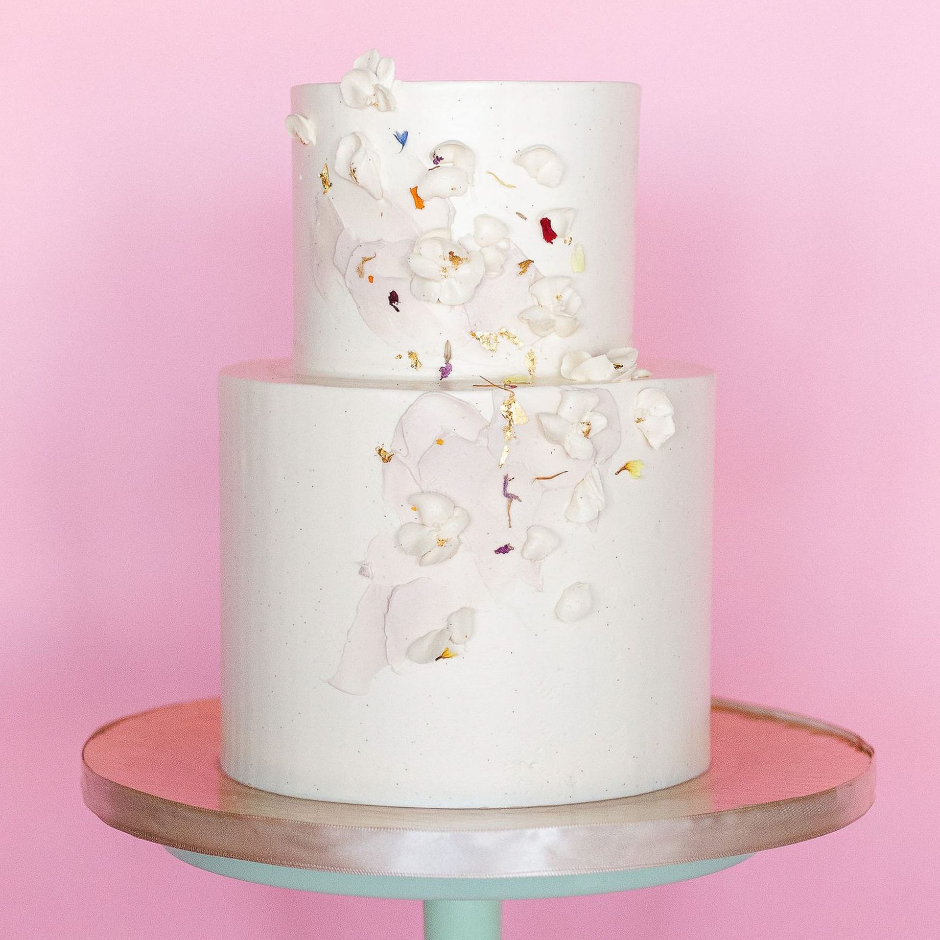 Two women are standing next to each other holding bouquets of flowers.