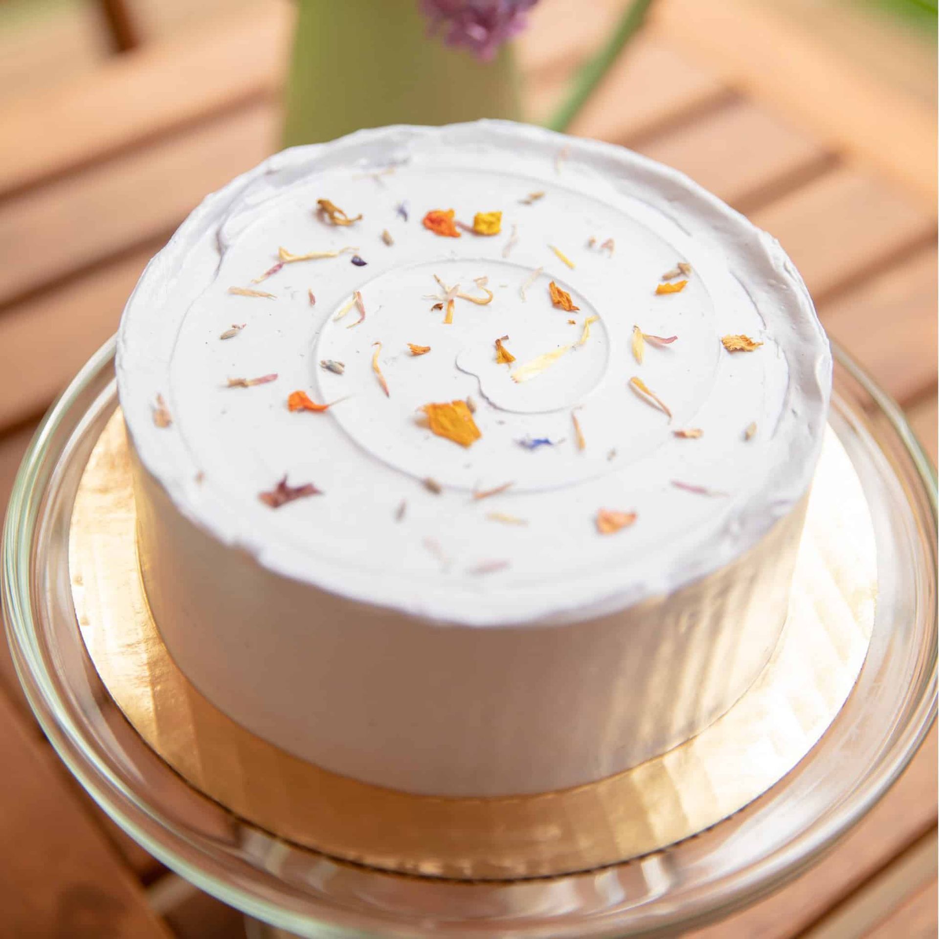 A bride and her bridesmaid are posing for a picture while the bride is holding a bouquet of flowers.