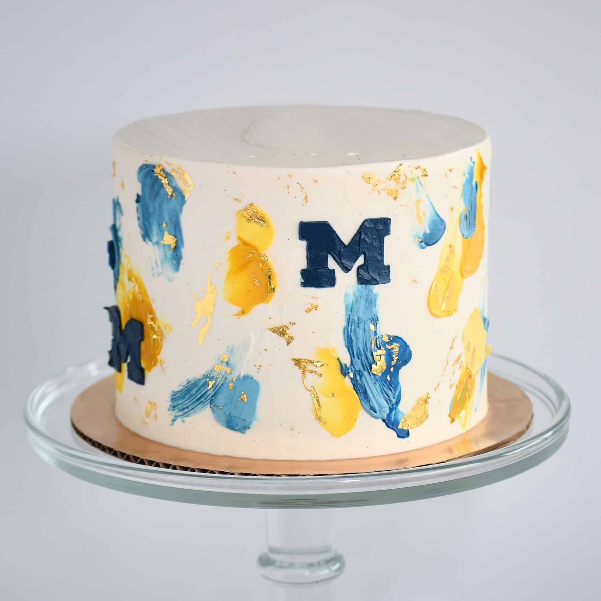 A bride in a white dress is holding a bouquet of red roses.