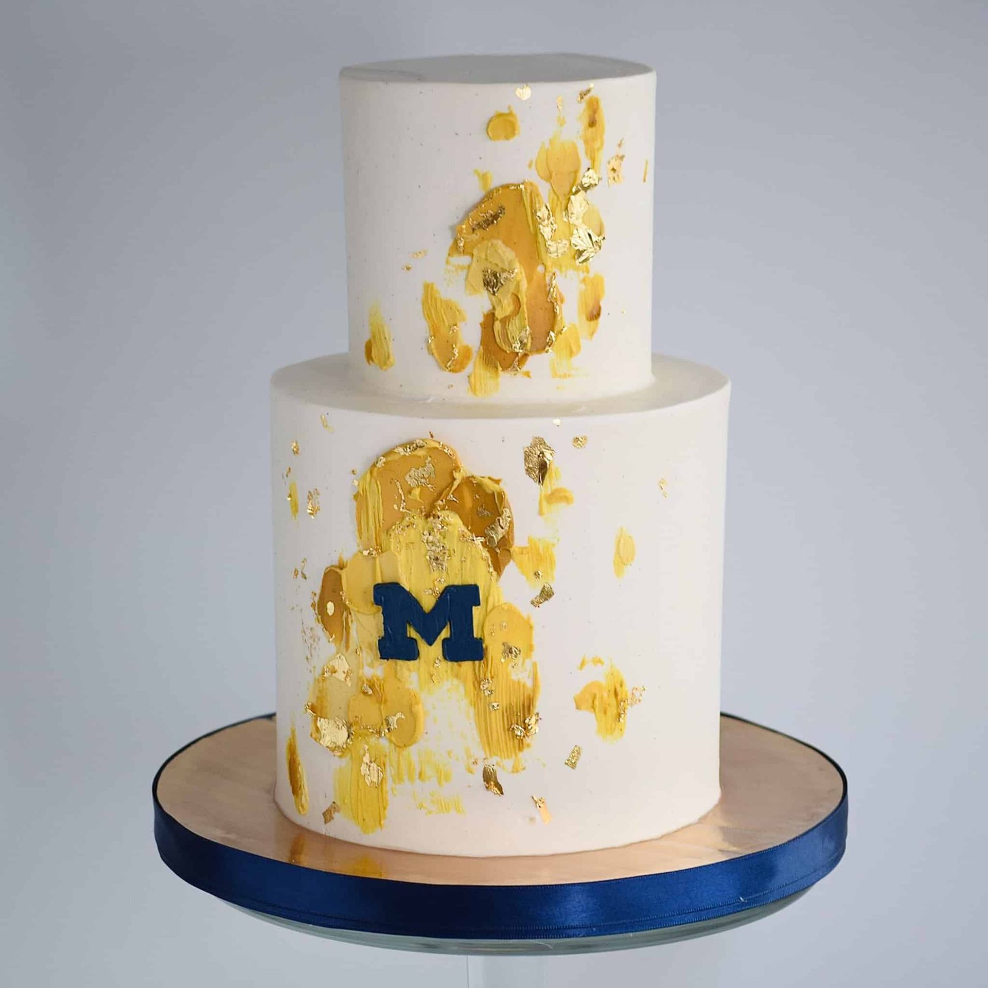 A bride in a white dress is holding a bouquet of red roses.