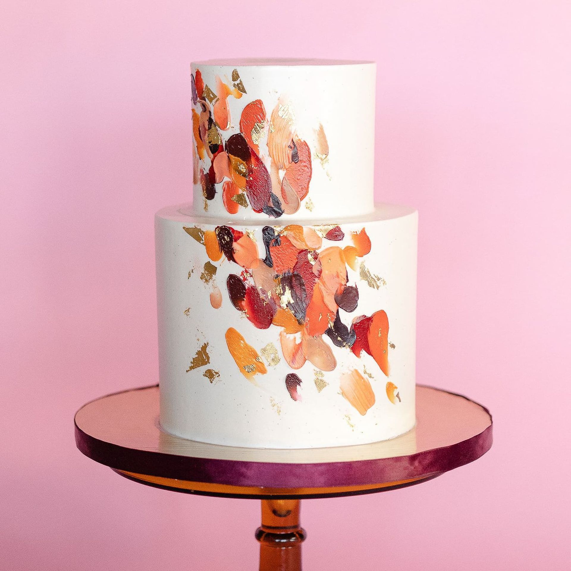 A bride in a wedding dress is holding a bouquet of yellow and blue flowers.