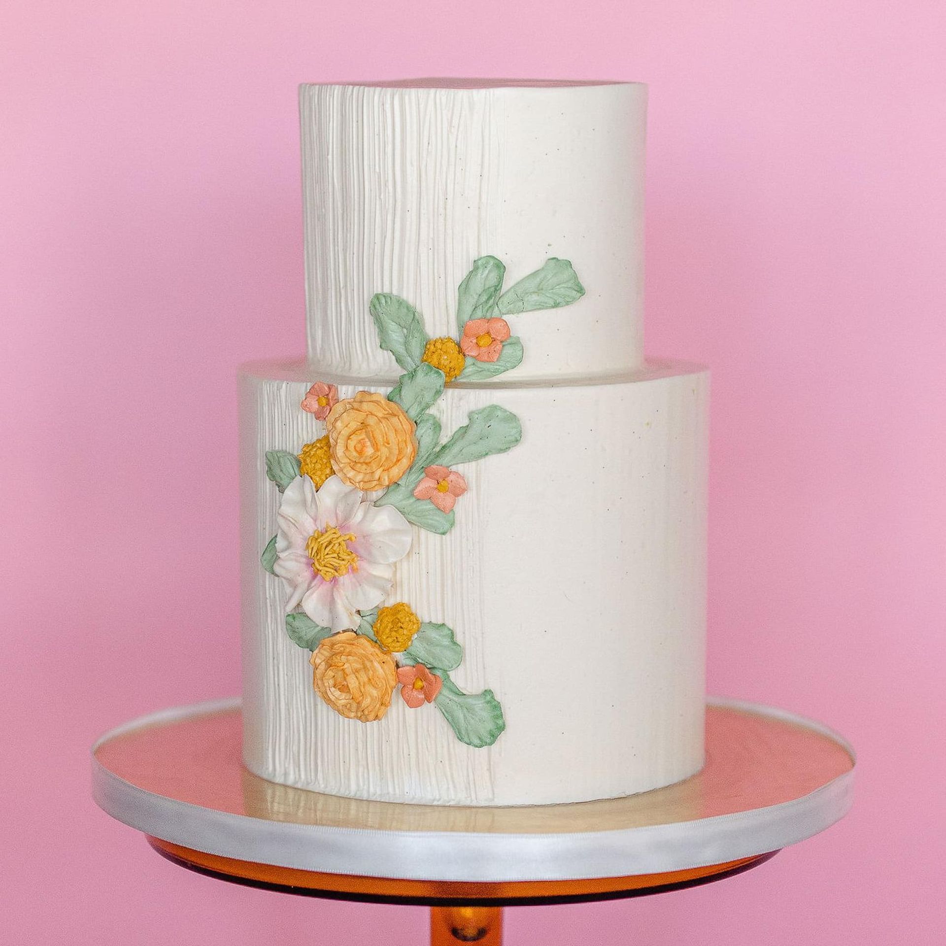 A woman in a white dress is holding a bouquet of flowers.