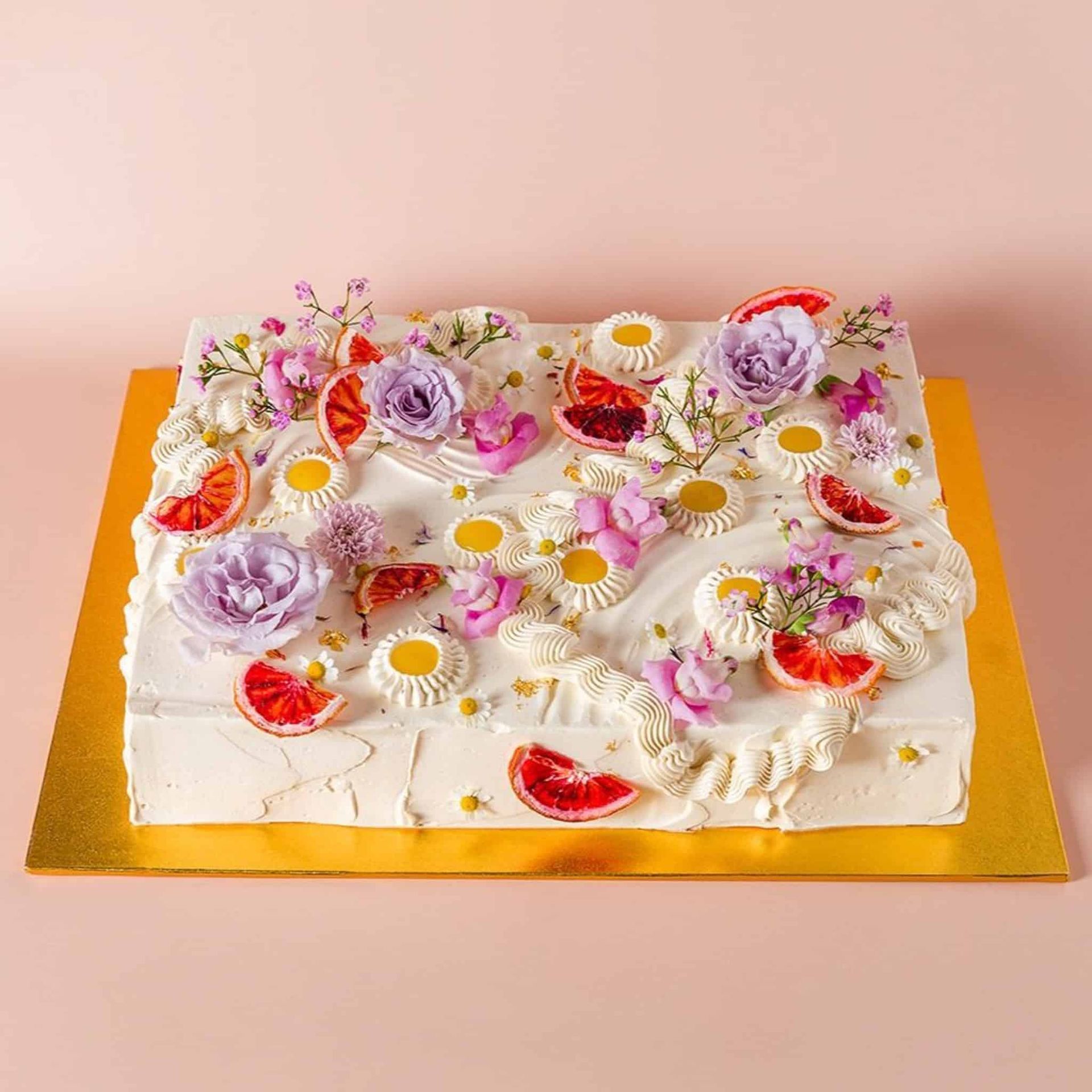 A bouquet of pink and red flowers in a vase on a table.