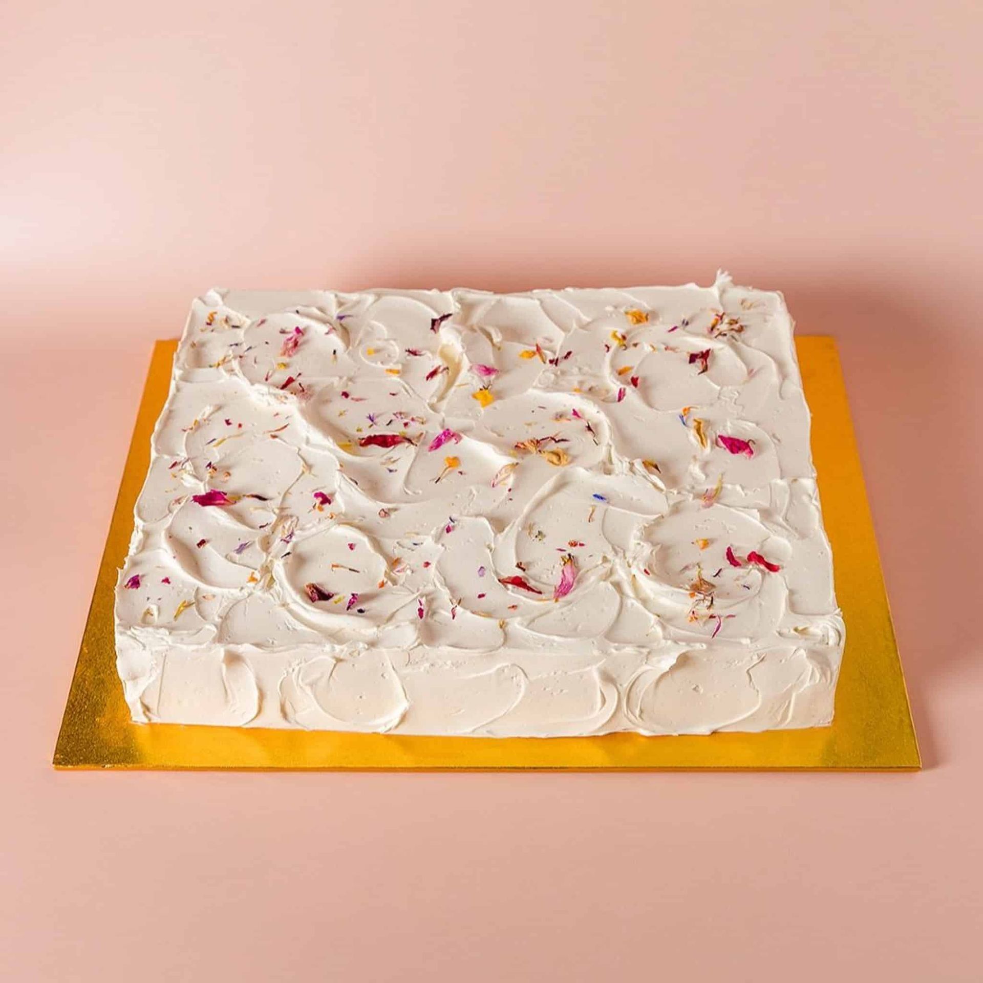 A woman in a white dress is holding a bouquet of flowers.