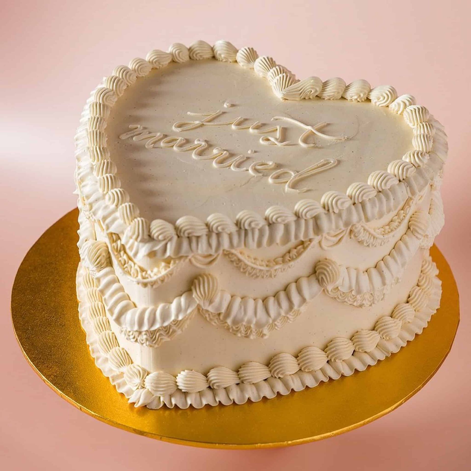 A bride in a wedding dress is holding a bouquet of yellow and blue flowers.