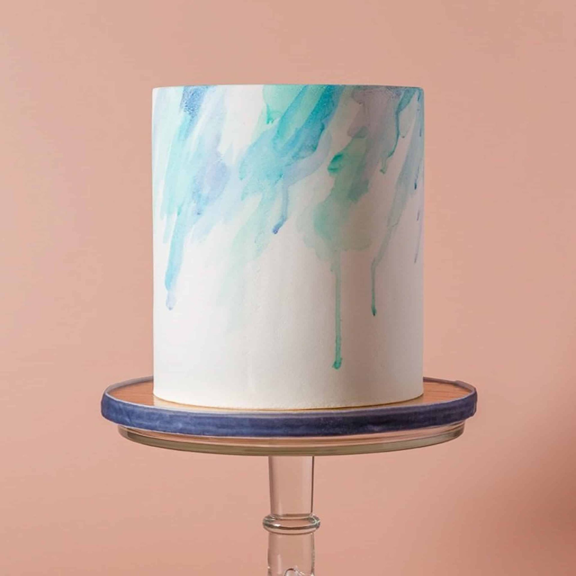 A bride in a white dress is holding a bouquet of white flowers.