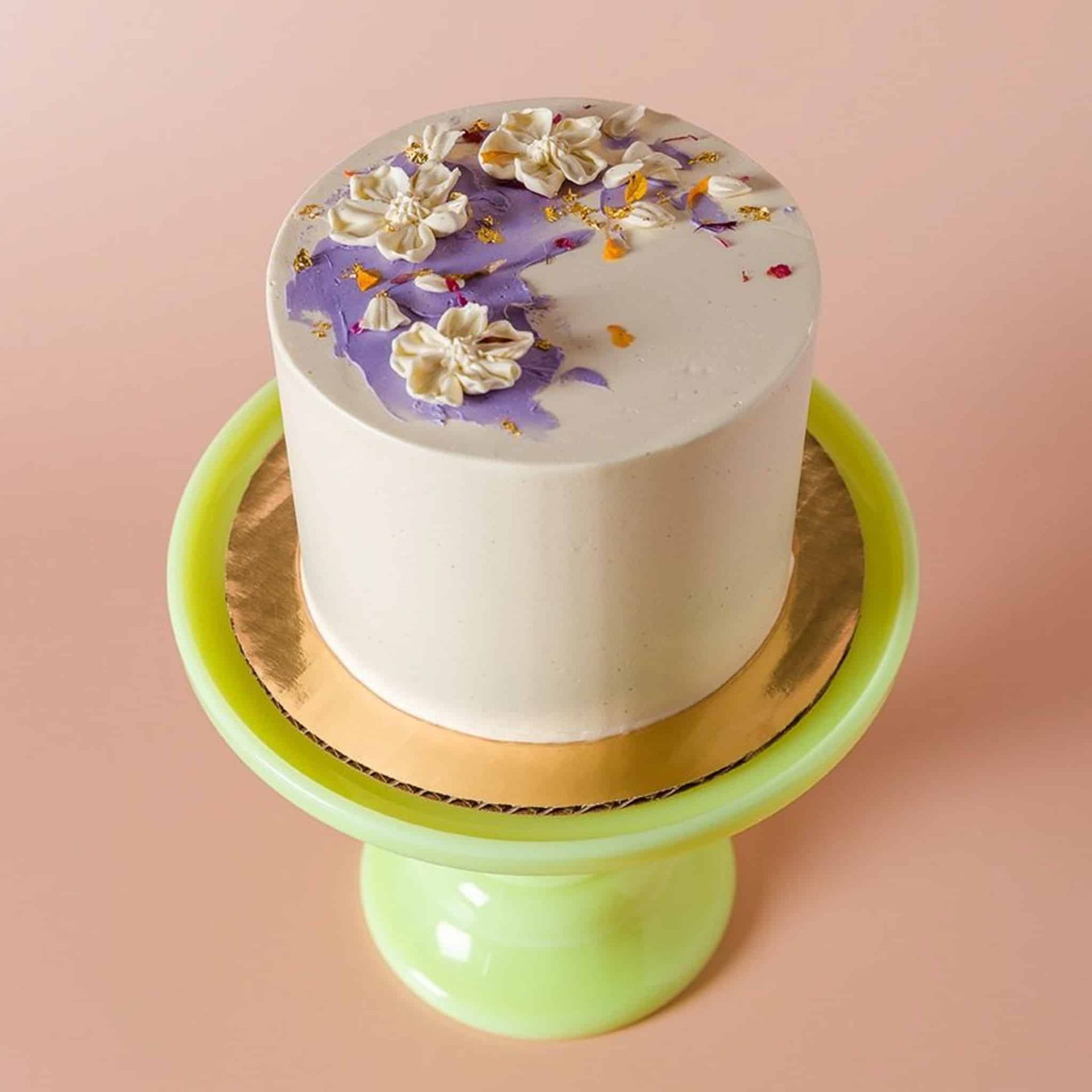 A bride with tattoos on her arms is holding a bouquet of flowers.