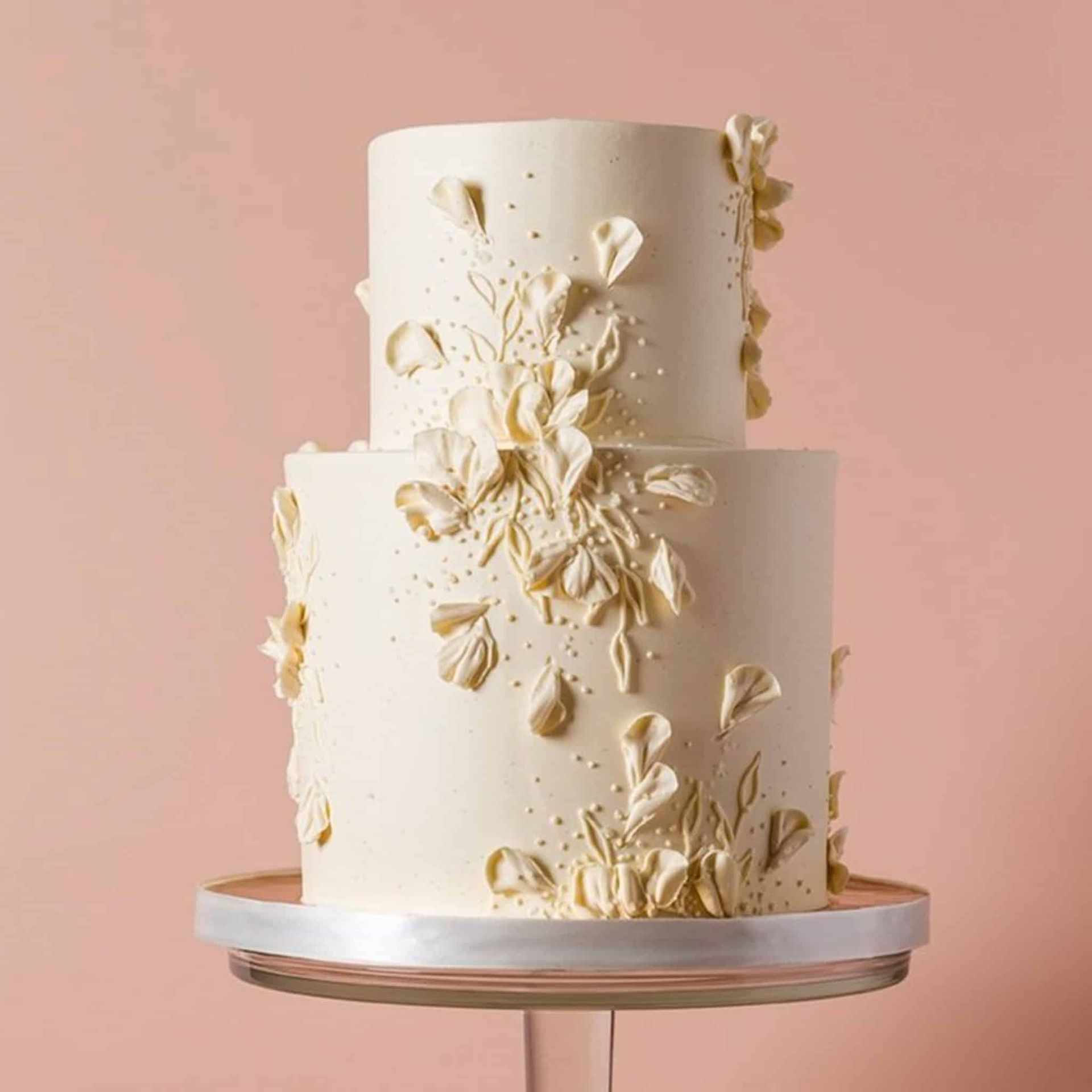 The bride is wearing a fur shawl and holding a bouquet of flowers.