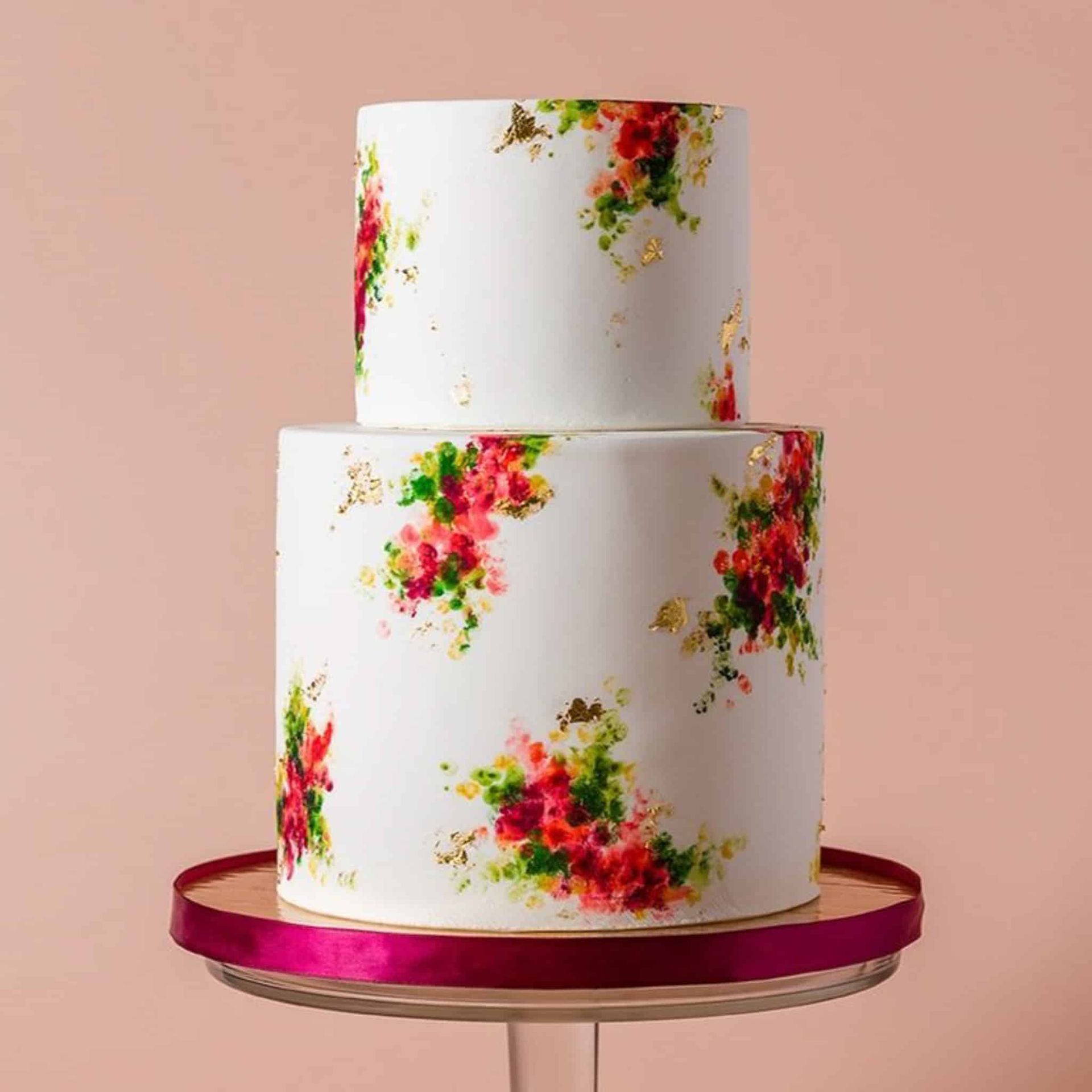 A bouquet of pink and red flowers in a vase on a table.