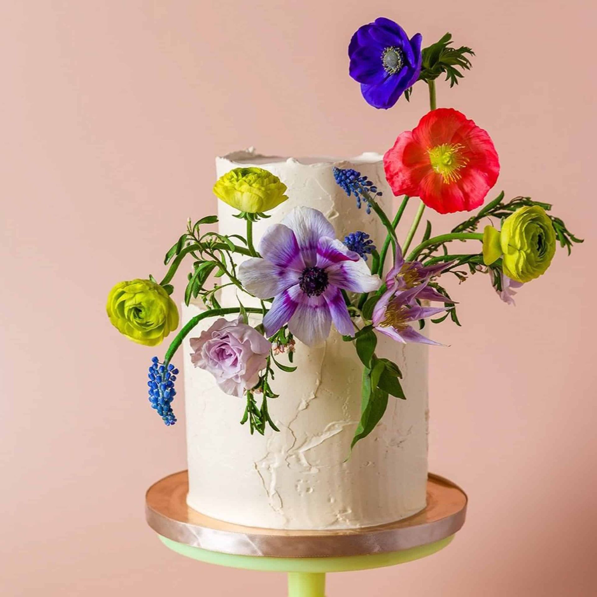 A woman in a white dress is holding a bouquet of pink and white flowers
