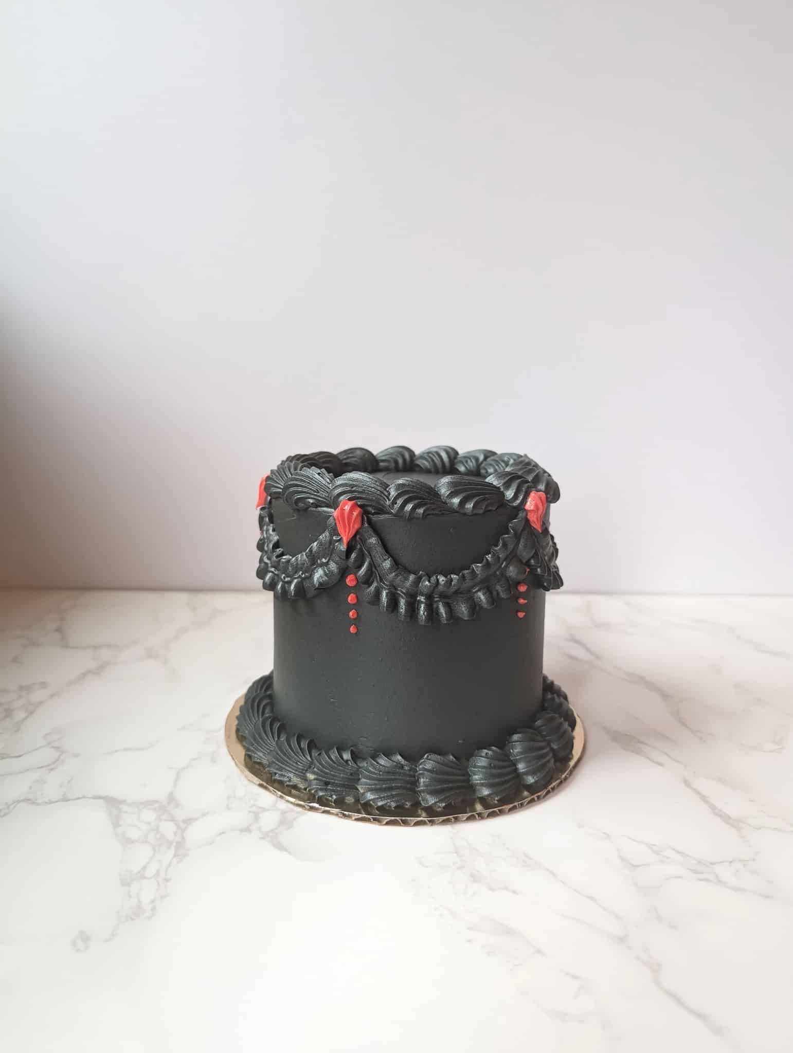 The bride is wearing a white cape and holding a bouquet of white flowers.