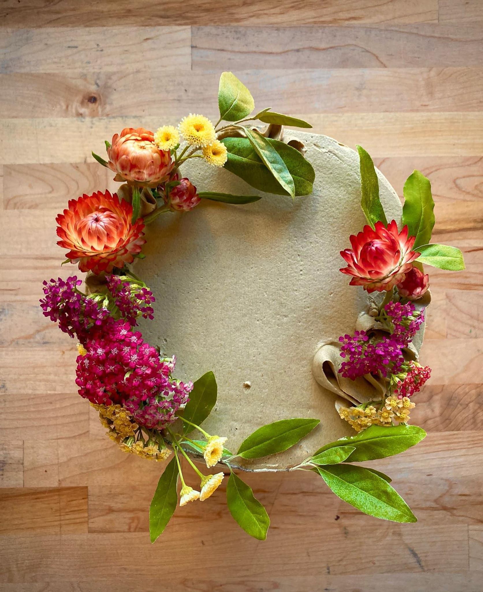A table with a vase of flowers and pumpkins on it.