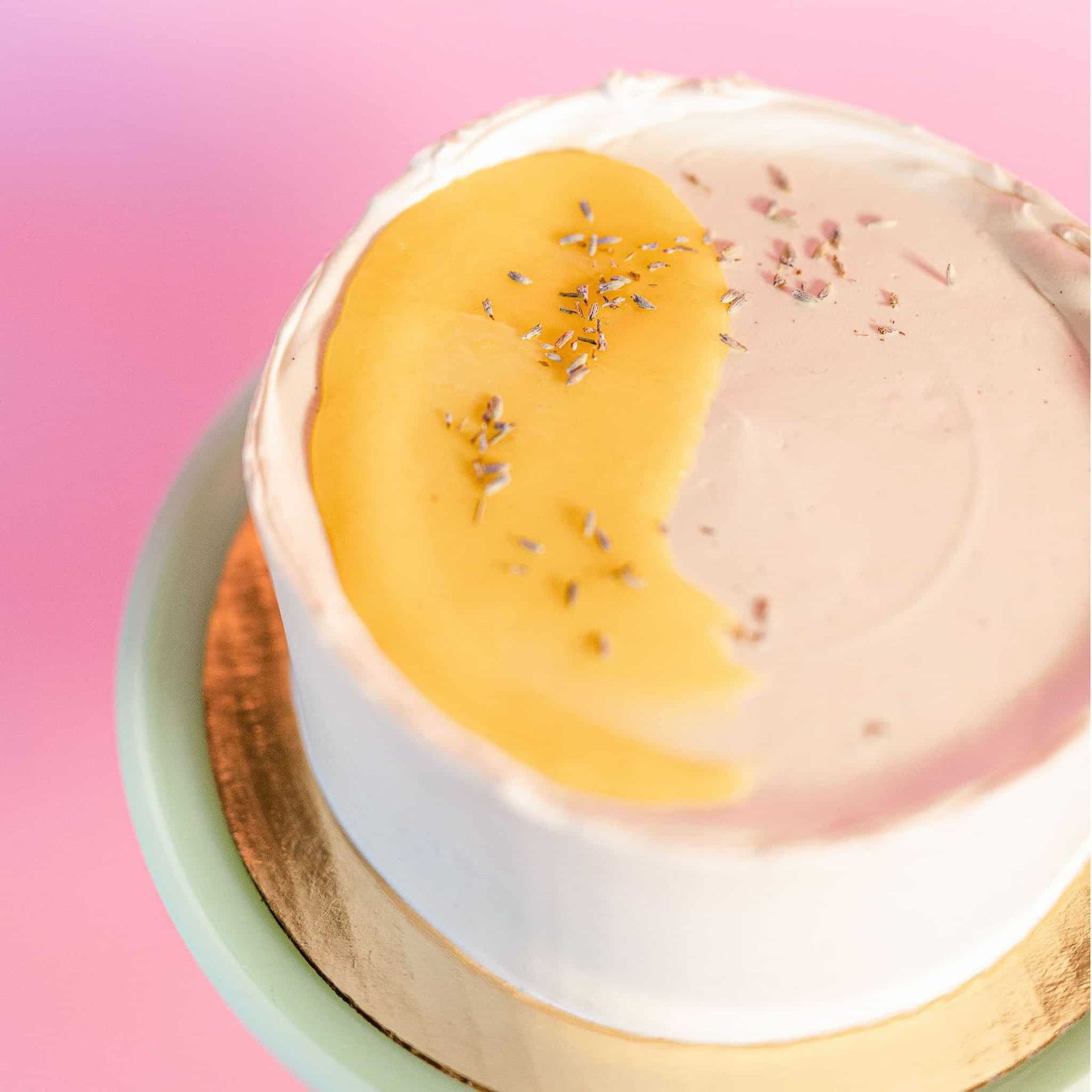 The bride is wearing a white cape and holding a bouquet of white flowers.
