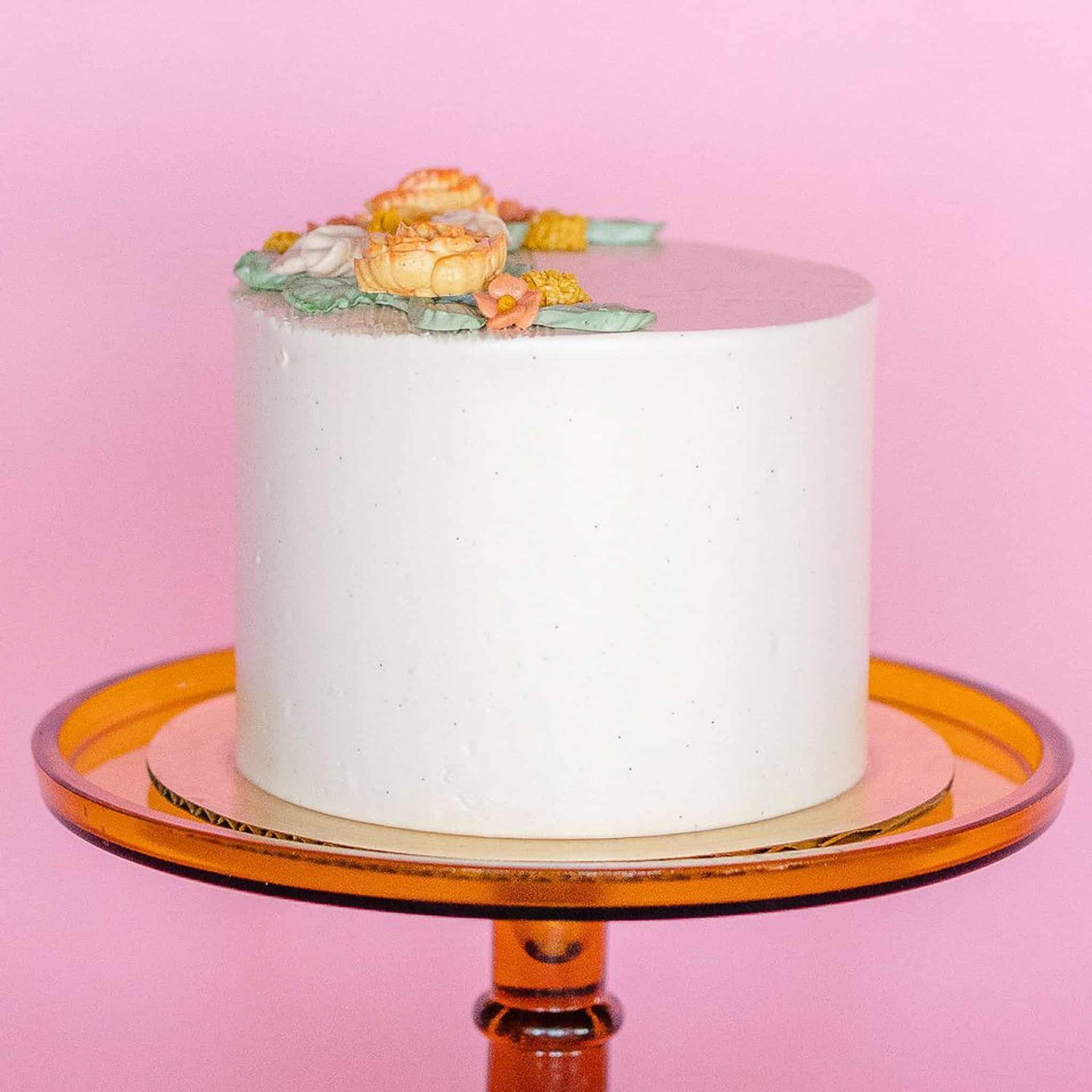 A woman in a wedding dress is holding a bouquet of flowers.