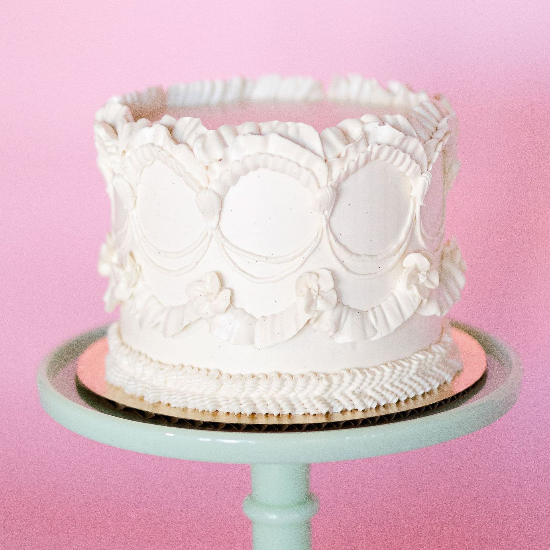 A woman in a white dress is holding a bouquet of blue and white flowers.