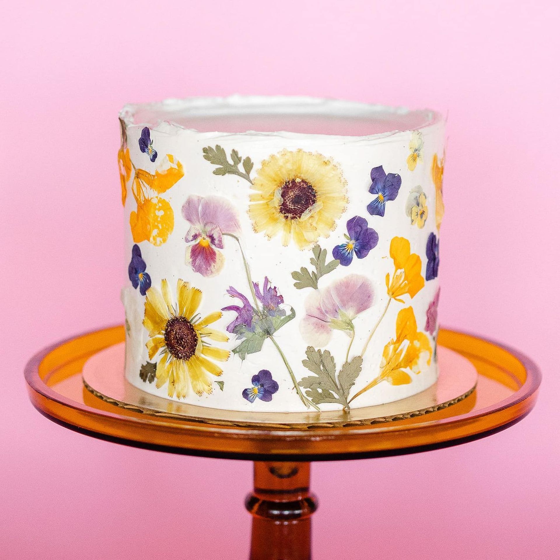 A woman in a white dress is holding a bouquet of pink and white flowers