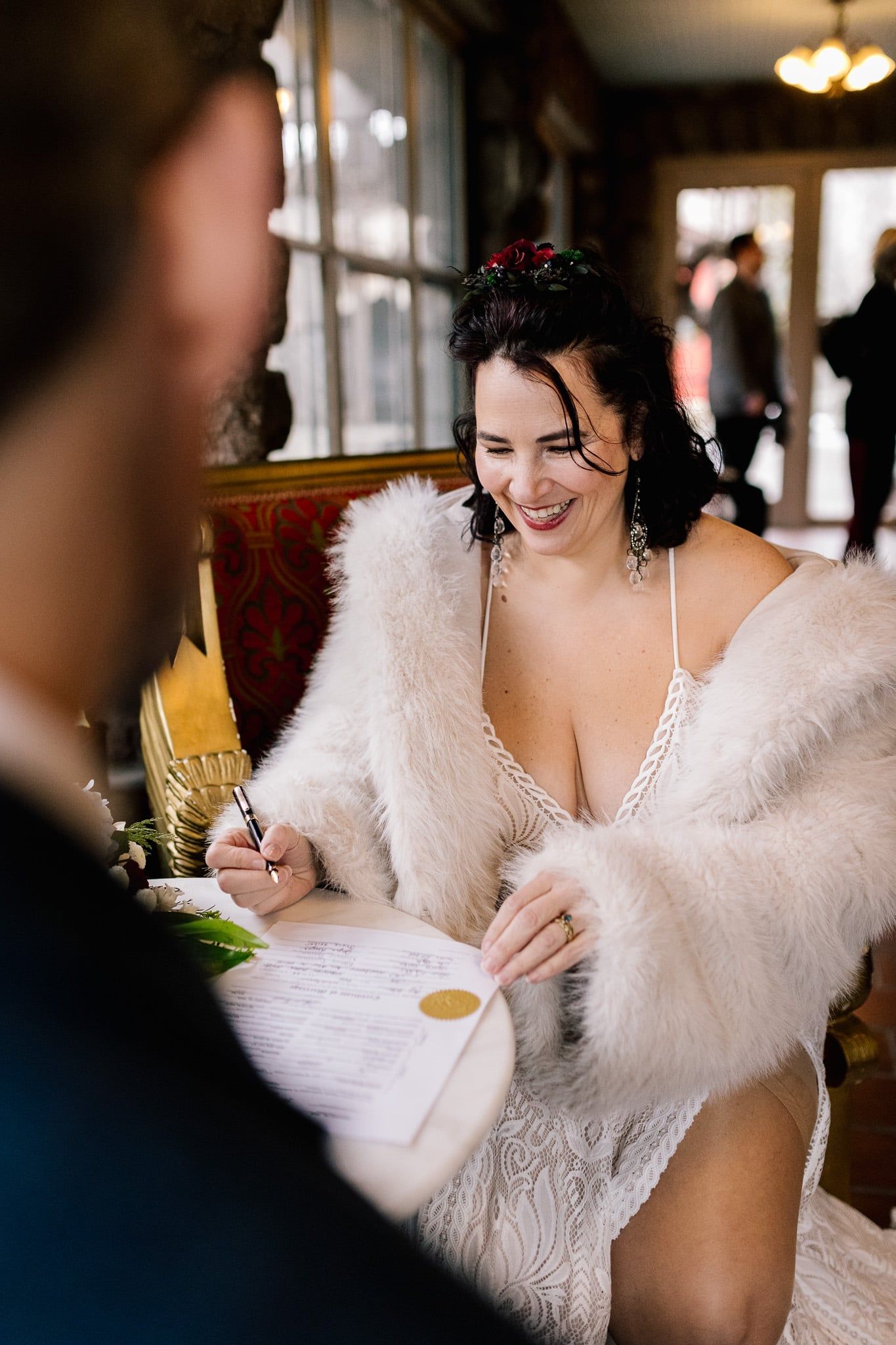 A woman in a fur coat is sitting at a table with a man.