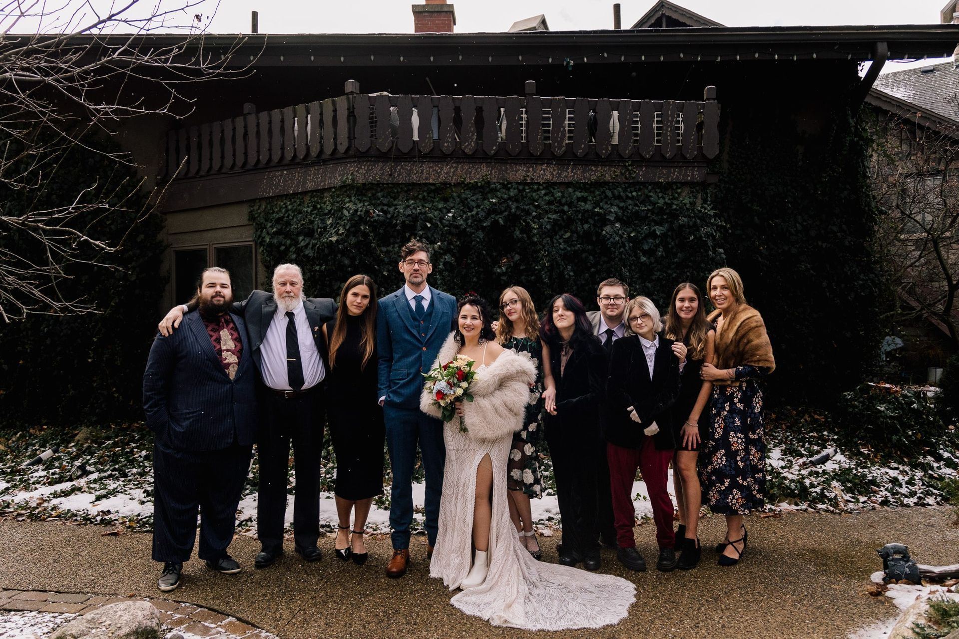 A group of people posing for a picture in front of a building.